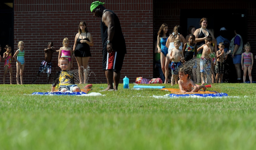 MOODY AIR FORCE BASE, Ga. -- Moody children take a break from their regular schedule and play on a water slide during Bible Camp here June 12. The water slide is one of several activities during the week-long camp held annually at the Base Chapel. (U.S. Air Force photo by Airman 1st Class Joshua Green)