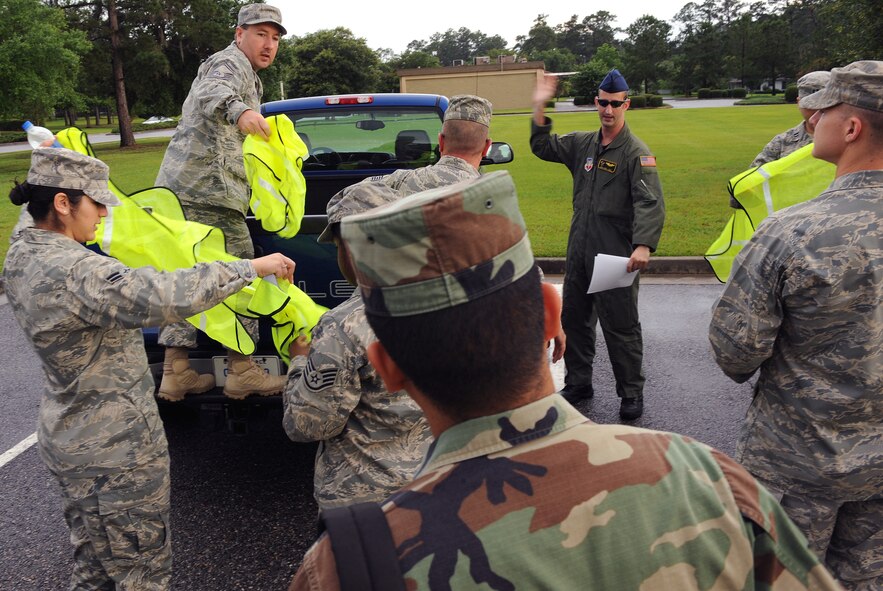 MOODY AIR FORCE BASE, Ga. -- Airmen receive green vests prior to starting Pride Patrol here June 5. Airmen wear the vests as a safety precaution for people driving along the highway. (U.S. Air Force photo by Airman 1st Class Joshua Green)