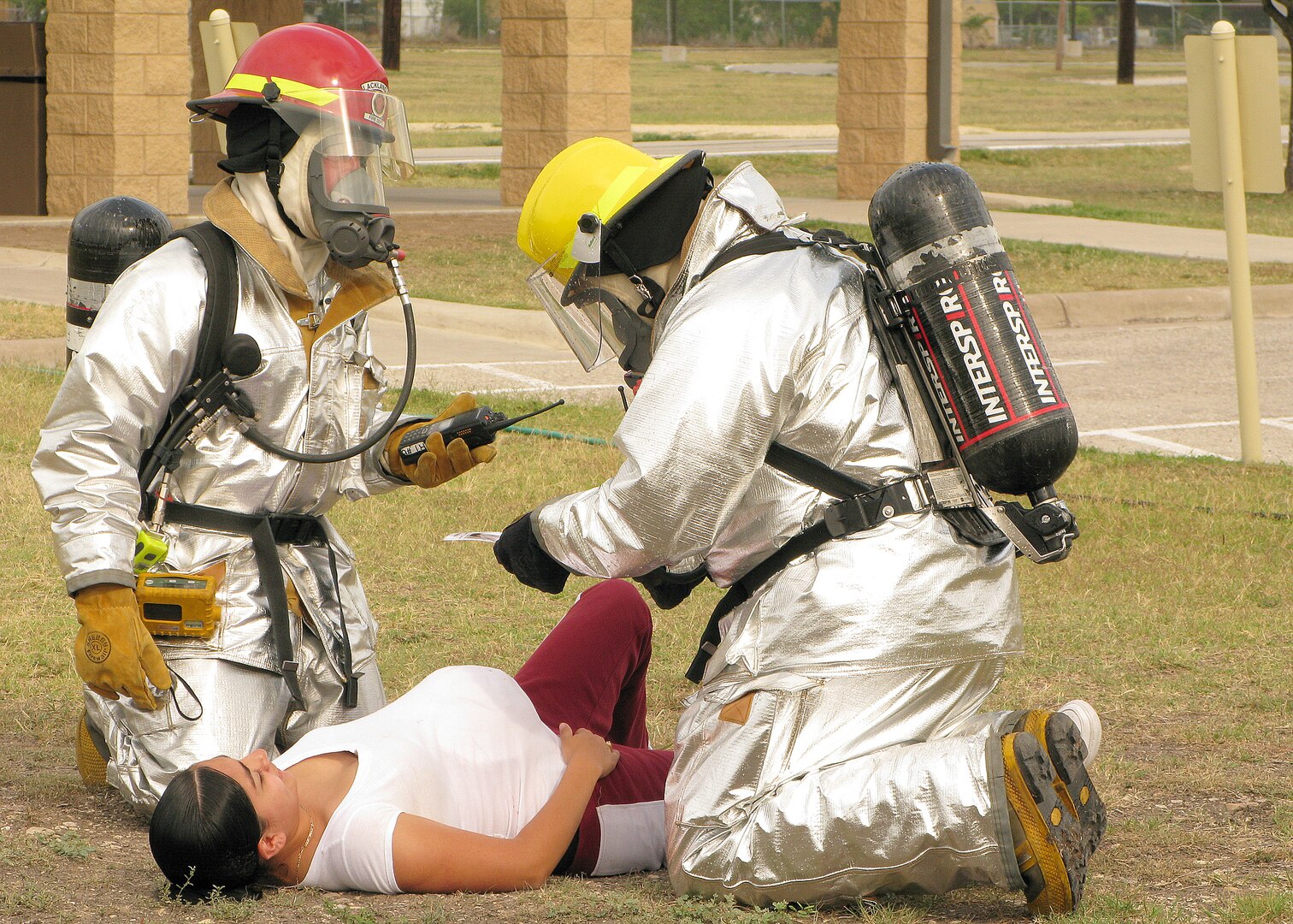 Firefighters from the 37th Civil Engineer Squadron assess a simulated injury during a major accident response exercise June 8. The training exercise tested the 37th Training Wing and the 59th Medical Wing on their ability to respond to a major incident. (U.S. Air Force photo/Robbin Cresswell)