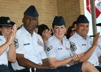 6/5/2009 - Chief Master Sgt. Juan Lewis (left), 37th Training Wing command chief, and Senior Airman Tara Gouveia (center), 37th Aerospace Medicine Squadron, watch trainees graduate from Air Force Basic Military Training June 5. (U.S. Air Force photo/Robbin Cresswell) 