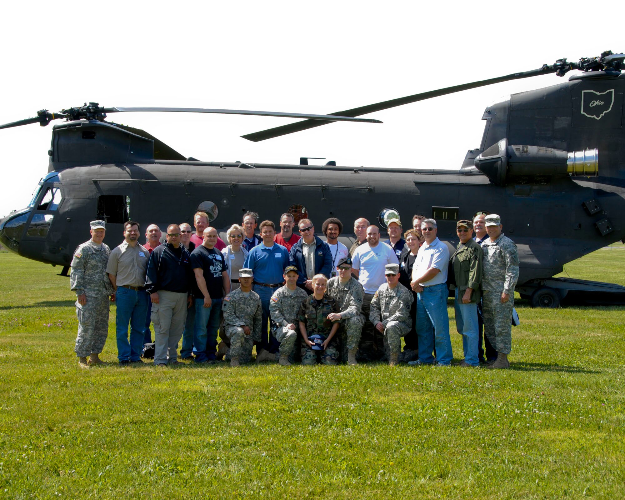 Employers of Ohio Air National Guard and Army National Guard servicemembers pose next to a Chinook helicopter during their visit to Camp Perry Joint Training Center before taking off to the 180th FW June 13, 2009 a joint employer event.