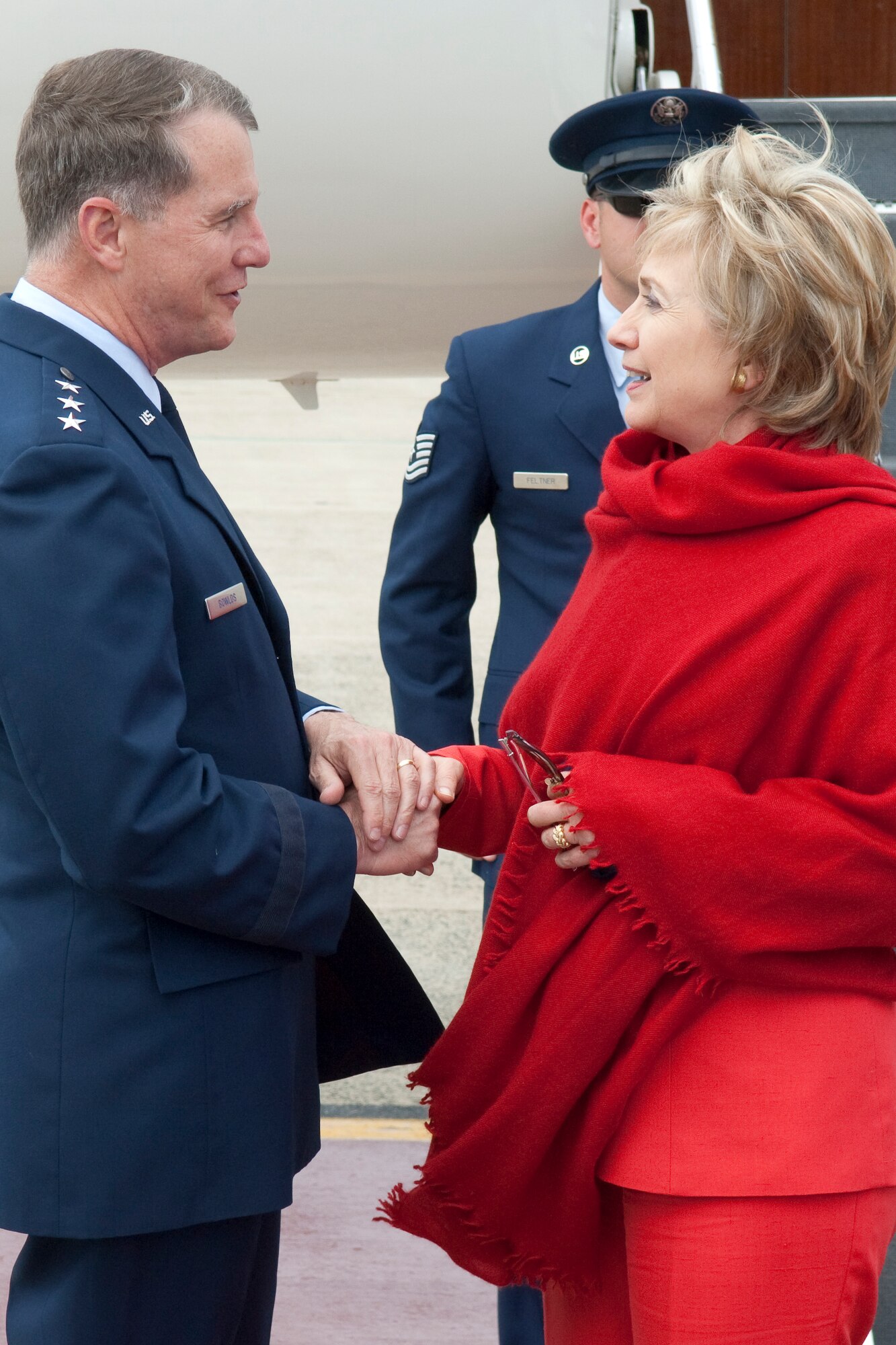 HANSCOM AIR FORCE BASE, Mass. -- U.S. Secretary of State Hillary Rodham Clinton shakes hands with Electronic Systems Center Commander Lt. Gen. Ted Bowlds upon arriving here June 13.  The secretary landed at Hanscom while on a short trip to the Boston area.  ((USAF Photo/Rick Berry)