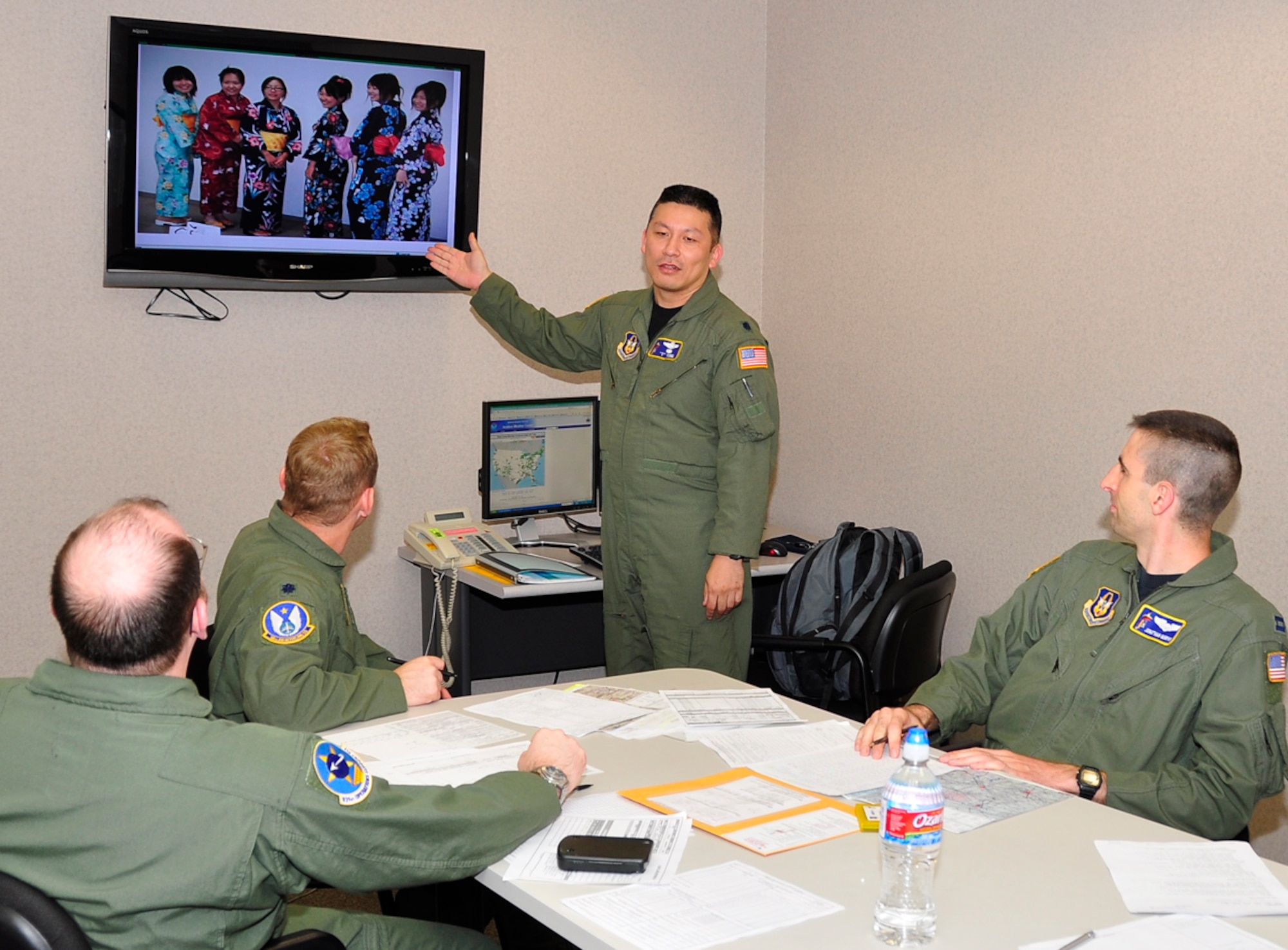 Lt. Col. Tsuyoshi "T" Tung uses some down time during a mission preflight to brief fellow crewmembers on traditional Japanese clothing called "yukata." The presentation was part of what Colonel Tung declared an Asian-Pacific American Heritage Sortie on May 27. Colonel Tung is a KC-135 pilot assigned to the 18th Air Refueling Squadron, the flying unit of the 931st Air Refueling Group. He was born in Japan and moved to the United States when he was 5 years old. (Courtesy photo/Tech. Sgt. Greg Carron)