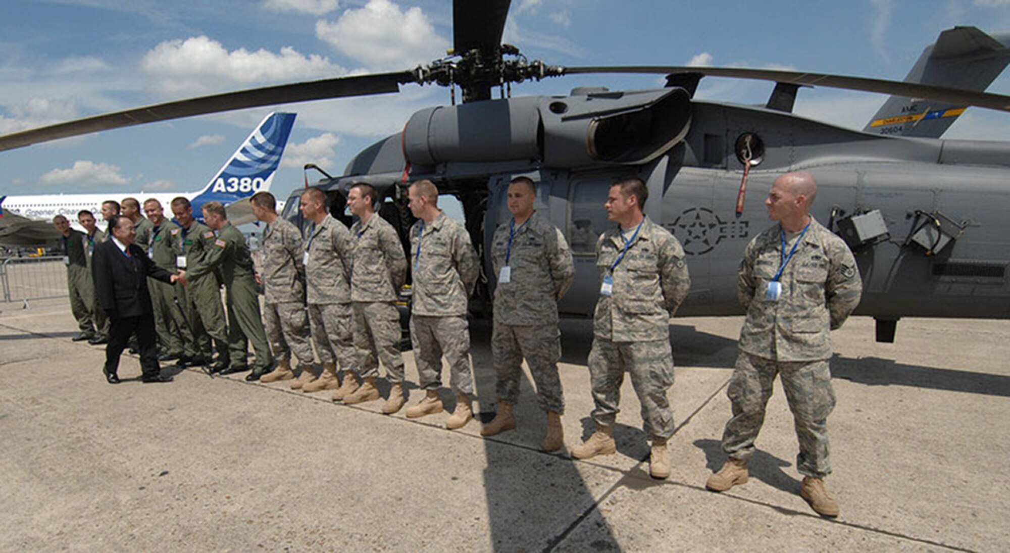 Senator Daniel K. Inouye of Hawaii shakes hands and lauds the pilots of the 41st Rescue Squadron and maintainers of the 723rd Aircraft Maintenance Squadron at Le Bourget Airport, France. Both units from Moody Air Force Base, Ga. proudly display their HH-60G Pave Hawk rescue helicopter. The Pave Hawk rescue helicopter is one of the several U.S. military aircraft put on show June 15 to 20 at the Paris Air Show. (Department of Defense photo/Master Sgt. Bill Gomez)