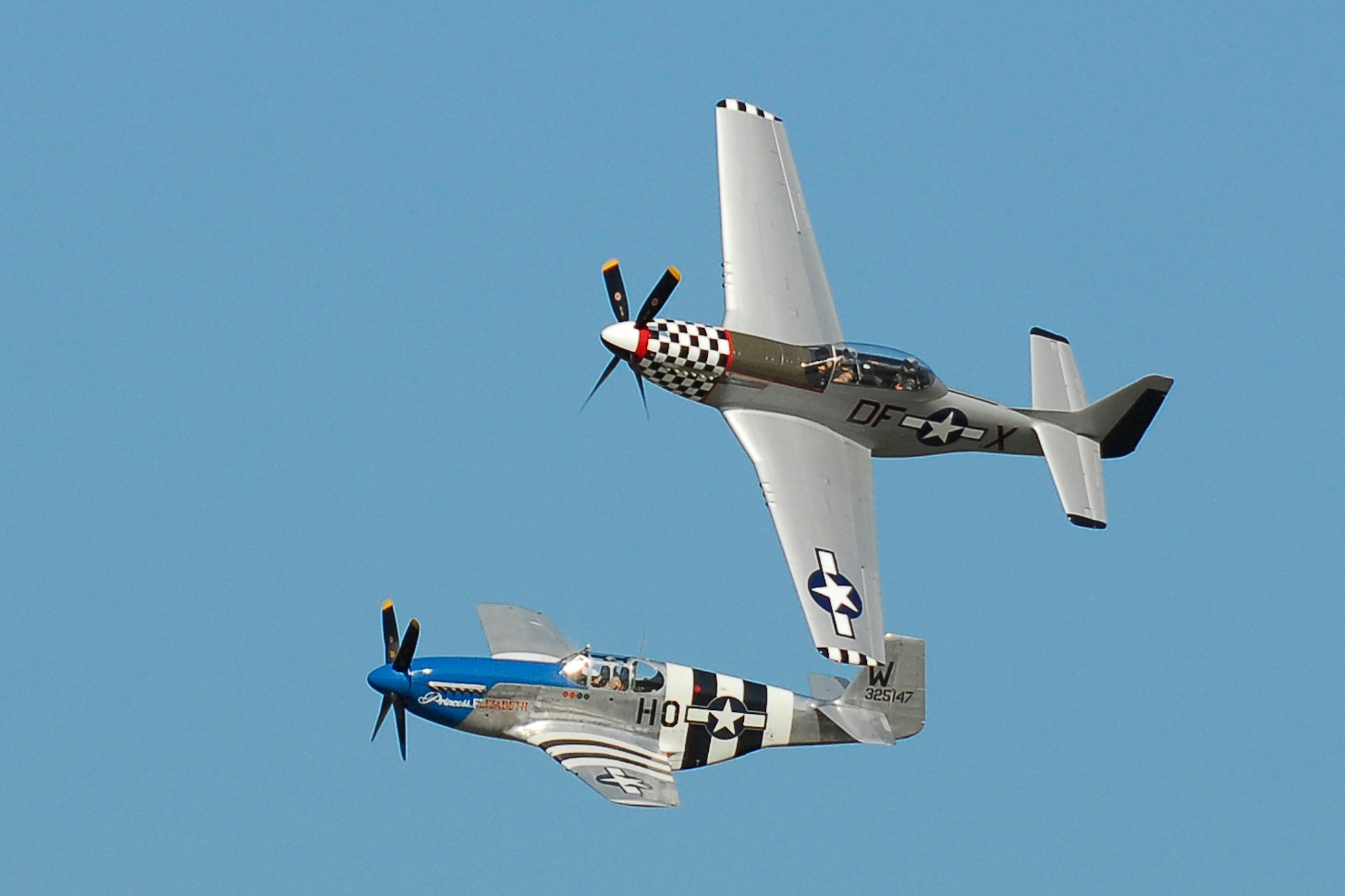A P-51D (top) and a P-51C belonging to The Horsemen aerobatic demonstration team fly over Kelly Field June 6. The two-seat Mustang offered rides to five enlisted Guardsmen of the 149th Fighter Wing.
(Texas Military Forces photo by Staff Sgt. Eric Wilson)