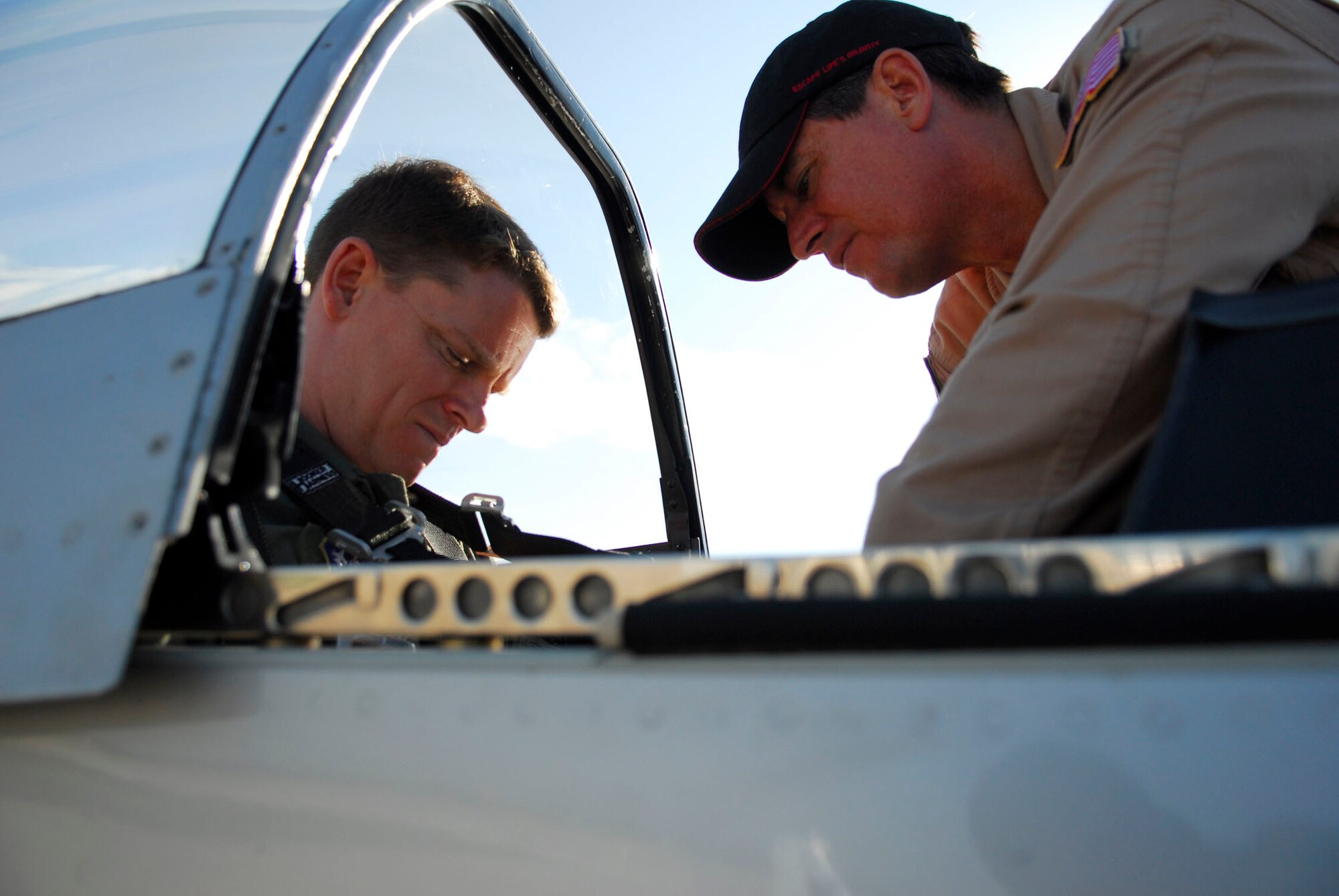 Tech. Sgt. Mark Hipp of the 149th Fighter Wing straps into the back seat of a P-51D Mustang with the help of pilot Ed Shipley. Sergeant Hipp was one of five members of the wing to receive a ride in the vintage aircraft out of San Antonio's historic Kelly Field June 6. (Texas Military Forces photo by Staff Sgt. Eric Wilson)