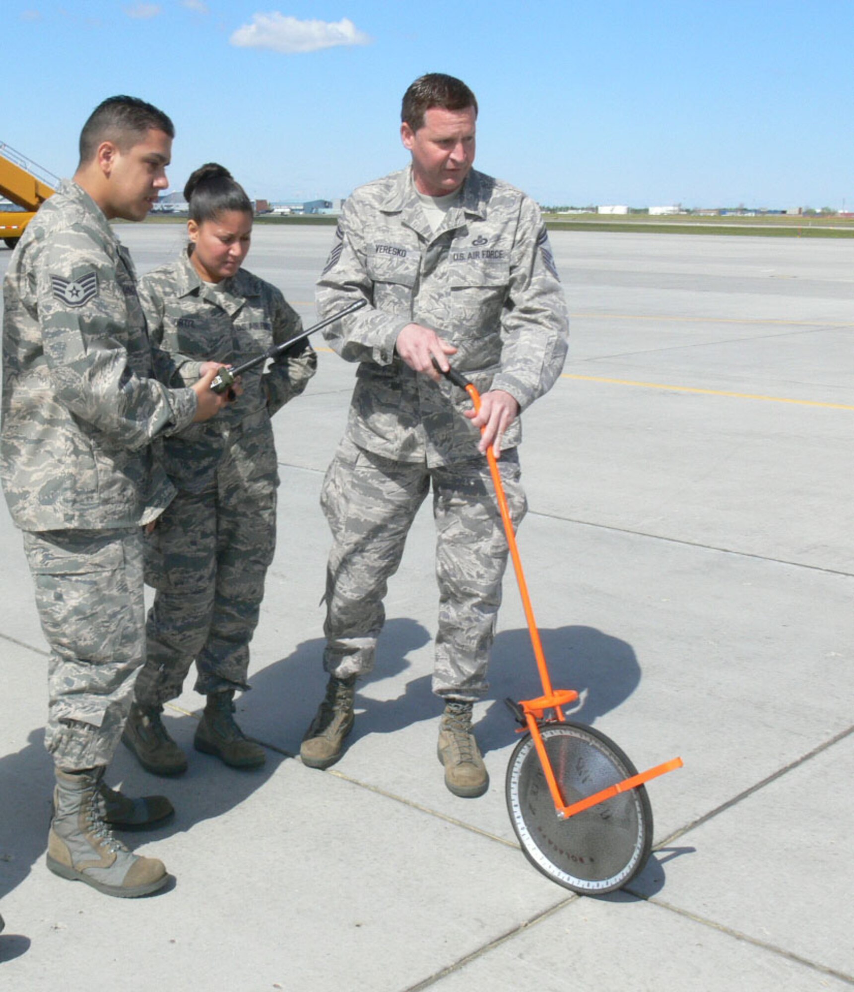 Senior Master Sgt. Paul Veresko of the 493th Airlift Control Flight Westover ARB, Mass. shows Staff Sgt Johnathan Concepcion and TSgt Julitssa Ortiz from the 512th ALCF Dover AFB, Del. how to measure distances when conducting an airfield survey. Airlift Control Flight members from Westover ARB, Mass. and Dover AFB, Del. participated in Maple Flag 42 at Cold Lake AB, Canada. (U.S. Air Force photo/2nd Lt Joe Simms)