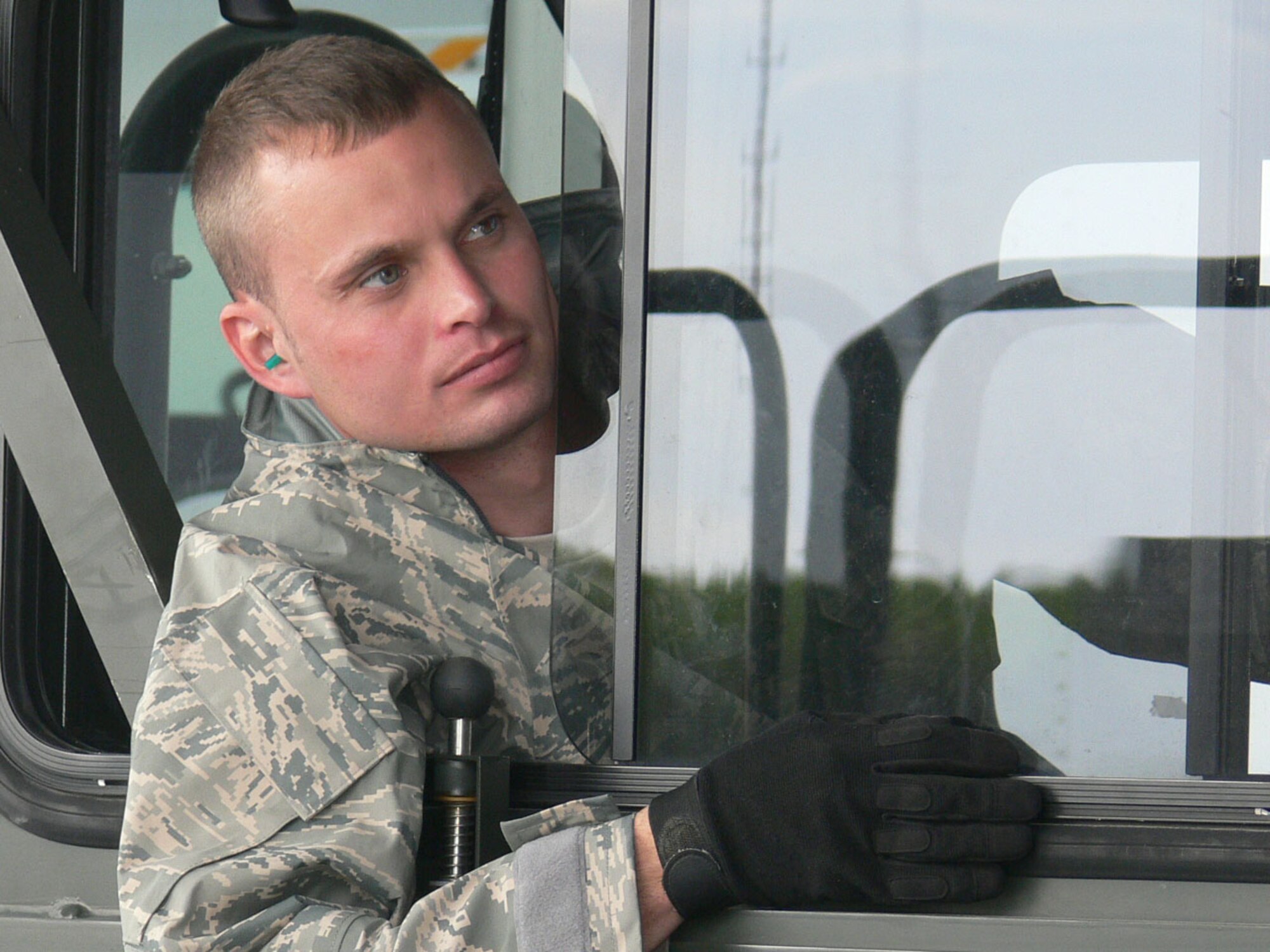 Senior Airman Johnathan Boyd of the 46th Aerial Port Squadron, Dover AFB, Del. watches his spotter while driving a K-Loader. The aerial porters from the 46th joined the 512th Airlift Control Flight in support of the Canadian Air Force during Maple Flag Exercise 42 in Cold Lake Alberta, Canada. (U.S. Air Force photo/2nd Lt Joe Simms)