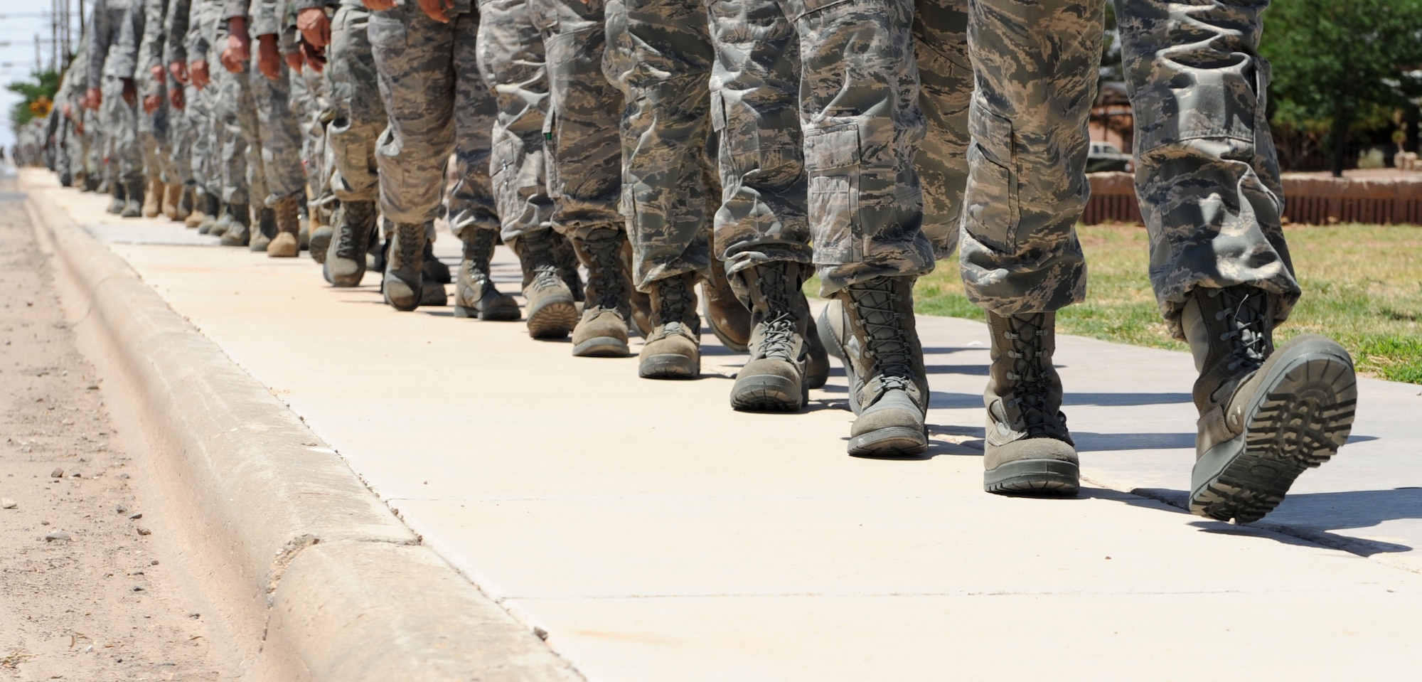 Members of Team Holloman march toward the front gate to render a final salute to Army Specialist Christopher Kurth June 11 at Holloman Air Force Base, N.M. The Soldier was killed in a grenade attack near Kirkuk, Iraq, June 4. Specialist Kurth was a native of Alamogordo, N.M., and was stationed at Fort Hood, Texas. (U.S. Air Force photo/Airman 1st Class Sondra Escutia)