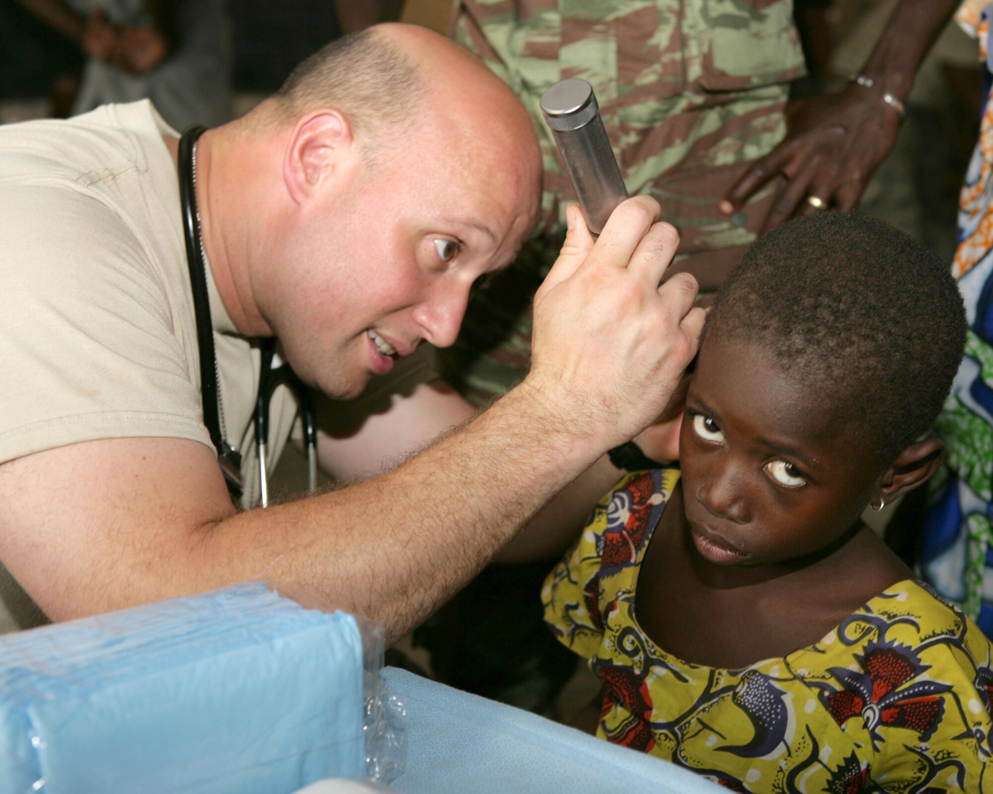 BEMBEREKE, Benin - Air Force Maj. Eric Colon, with the 459th Expeditionary Air Medical Squadron, performs a routine physical examination at Wanrarou, Benin, local during day one of a six-day Medical Civil Assistance Program coordinated by the 459th EAMDS and three Benin Army doctors. The 459th is a provisional part of the 404th Air Expeditionary Group at 17th Air Force. 
The program is part of Exercise SHARED ACCORD 09, a scheduled, 15-day bilateral Benin-U.S. exercise. Also know as Air Forces Africa, 17th coordinated the air component participation and contribution to the exercise. The exercise is scheduled to conclude June 25, 2009. (Photo by U.S. Marine Cpl. Lydia M. Davey)