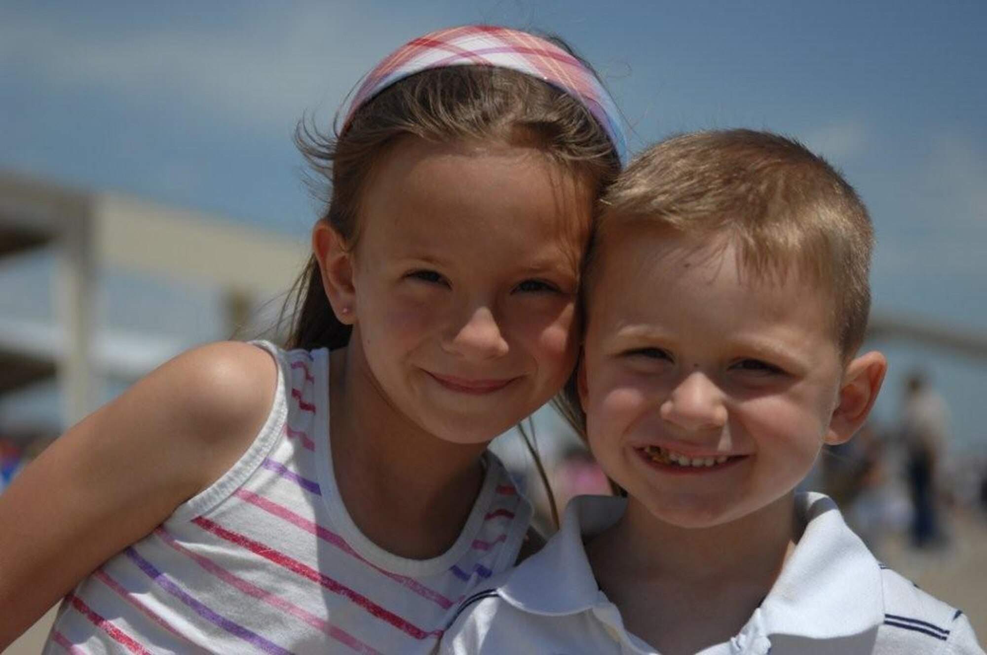 WARRENSBURG, Mo. - Madison and Brady Close, children of Tech. Sergeant Jason Close 509th Munitions Squadron took a break from their pretzels to pose for a photograph at the Wings Over Whiteman Air Show June 6. A rock climbing wall, NASA bouncing display and other attractions fill the children’s area at the air show.(U.S. Air Force photo/ Senior Airman Stephen Linch) 