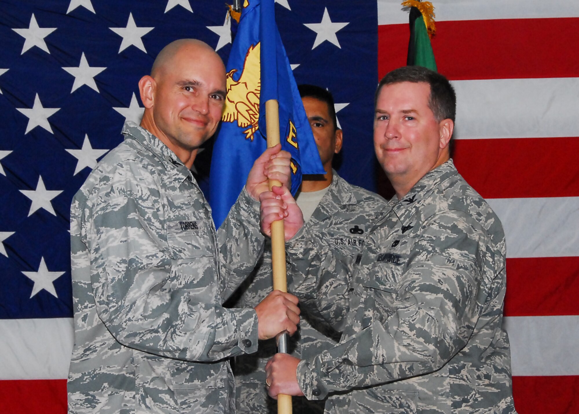 SOUTHWEST ASIA -- Col. Andrew Molnar assumes command of the 386th Expeditionary Maintenance Group from Col. Cameron Torrens, 386th Air Expeditionary Wing commander, at an air base in Southwest Asia, June 15.  Colonel Molnar is deployed from Scott Air Force Base, Ill. (U.S. Air Force photo/Senior Airman Courtney Richardson)