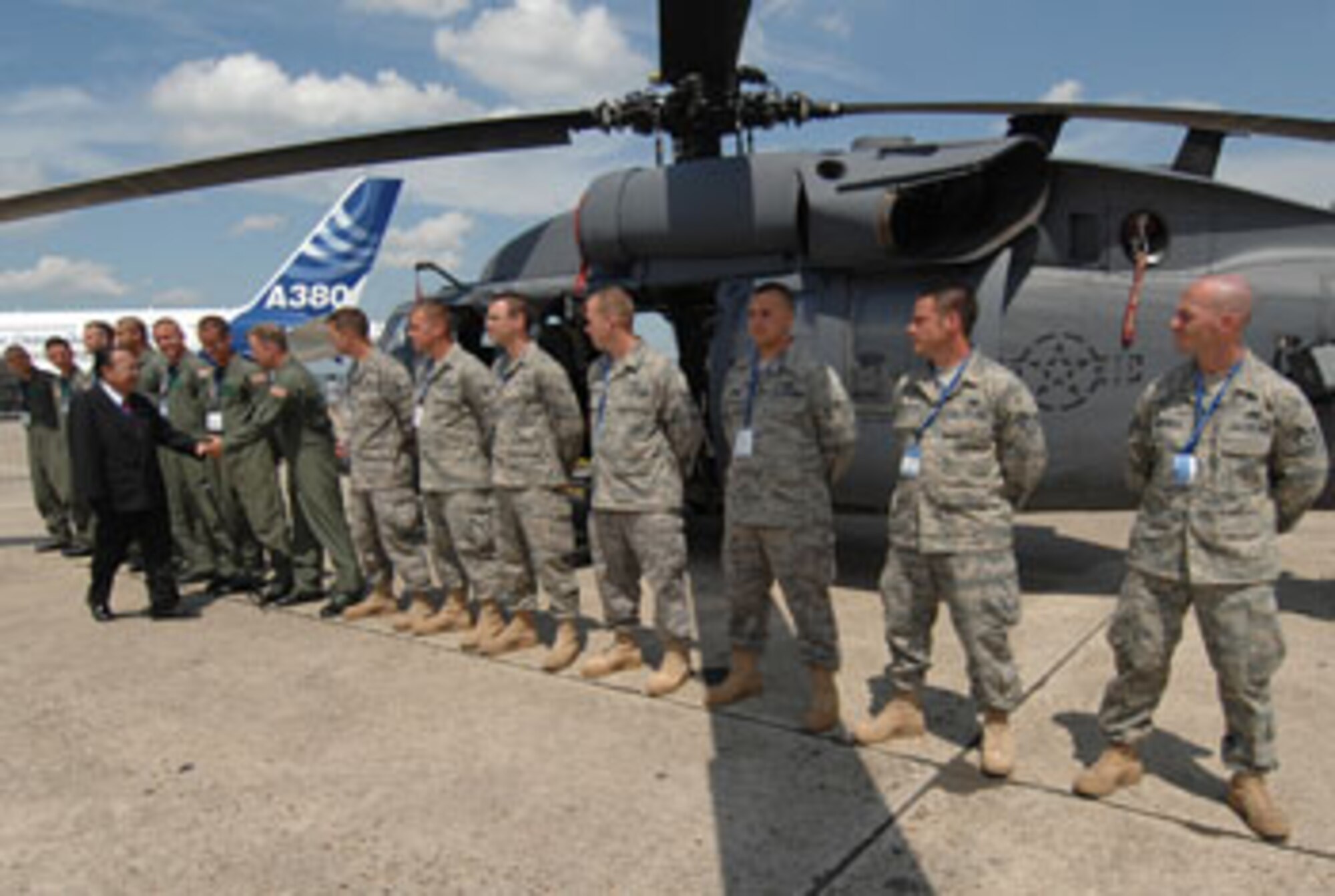 LE BOURGET AIRPORT, France — Senator Daniel K. Inouye of Hawaii shakes hands and lauds the pilots of the 41st Rescue Squadron and maintainers of the 723rd Aircraft Maintenance Squadron. Both units from Moody Air Force Base, Ga. proudly display their HH-60G Pave Hawk rescue helicopter. The Pave Hawk rescue helicopter is one of the several U.S. military aircraft put on show 15-20 June at the Paris Air Show 2009. (Department of Defense photo by Air Force Master Sgt. Bill Gomez)