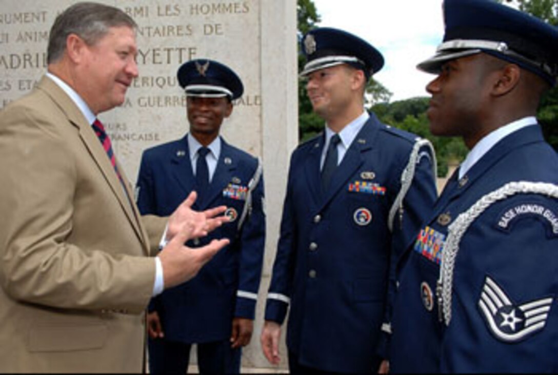 MARNES-LA-COQUETTE, FRANCE — Secretary of the Air Force Michael B. Donley praises Tech. Sgt. Mike Jackson, 1st Lt. Chris McDaniels and Staff Sgt. Fred Stevenson, members of the 52nd Fighter Wing, Spangdahlem Air Base Honor Guard in Germany, for their support to the wreath laying ceremony at the Memorial de l'Escadrille La Fayette just outside of Paris June 13. The ceremony attended by U.S. senators, the Secretary of the Air Force, U.S. and French dignitaries, paid honor to the American volunteer combat flying aces known as the "Lafayette Escadrille" who flew under the French flag during World War I. (Department of Defense photo by Master Sgt. Bill Gomez)