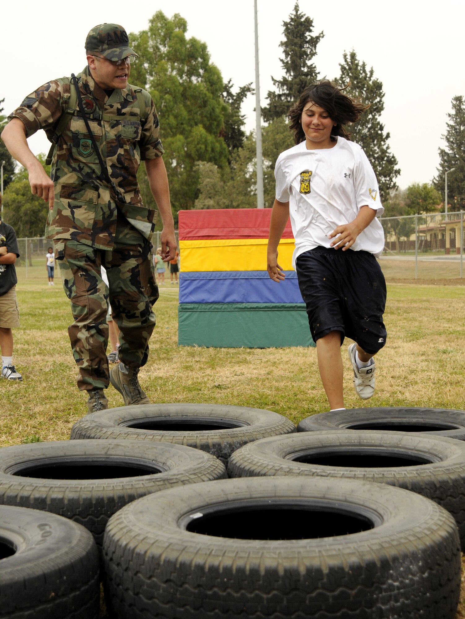 James Medellin, son of Staff Sgt. Chris Galindo, 39th Air Base Wing, is followed through the obstacle course by mock “training instructor” Staff Sgt. Ismael Rodriguez, 728th Air Mobility Squadron, during the Youth Center kids mini-boot camp, Thursday, May 11, 2009 at the softball field at Incirlik Air Base, Turkey. The course was set up for children to gain a little knowledge of what their military parents went through during basic military training and training for deployments. (U.S. Air Force photo/Airman 1st Class Amber Russell)