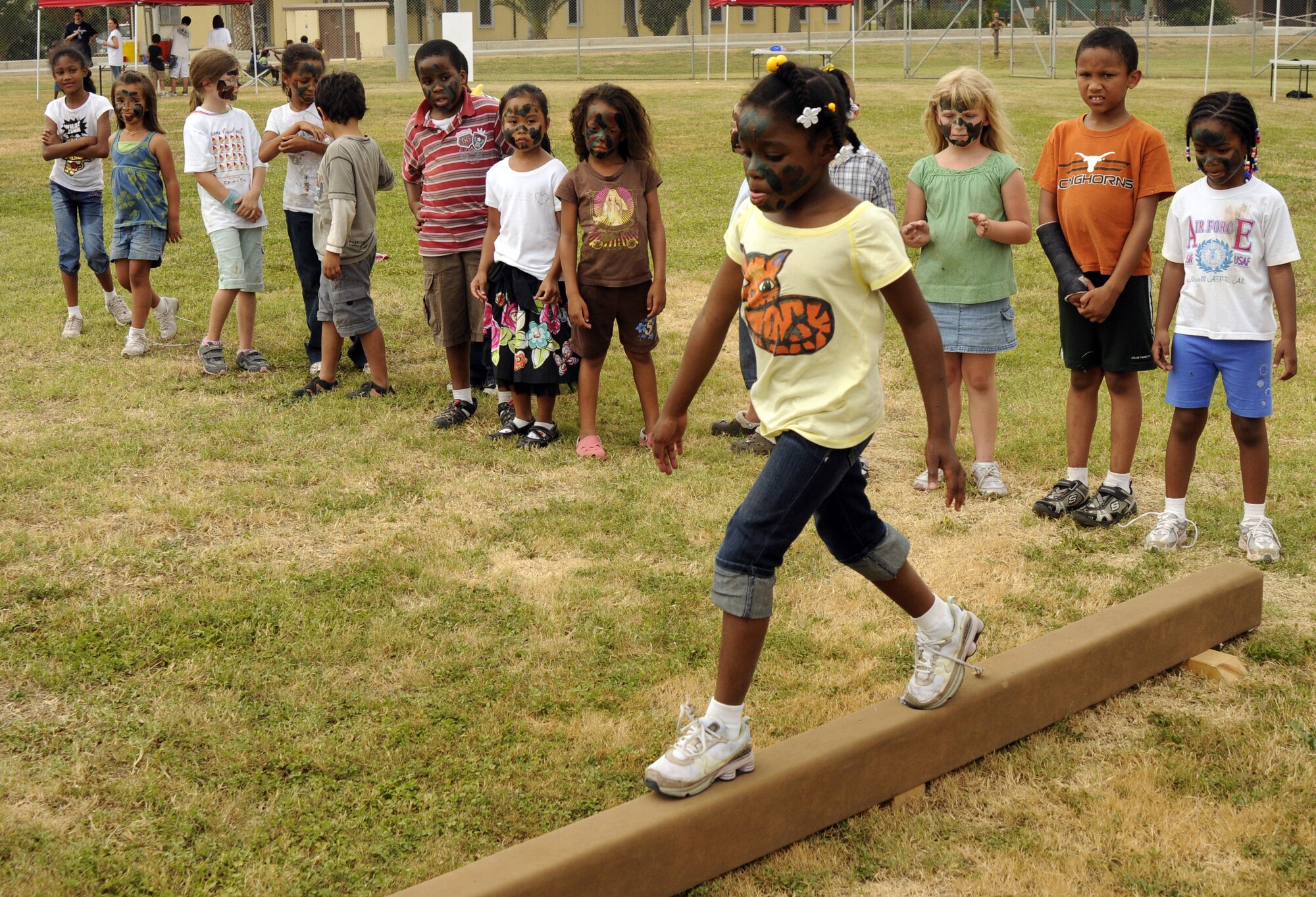 Jaliyah Johnson, daughter of Staff Sgt. Trunitta Maye, 728th Air Mobility Squadron, demonstrates for her peers how to walk along the balance beam during the Youth Center kid’s mini-boot camp at the softball field, Thursday, May 11, 2009 at Incirlik Air Base, Turkey. The course was set up for children to gain a little knowledge of what their military parents went through during basic military training and training for deployments. (U.S. Air Force photo/Airman 1st Class Amber Russell)