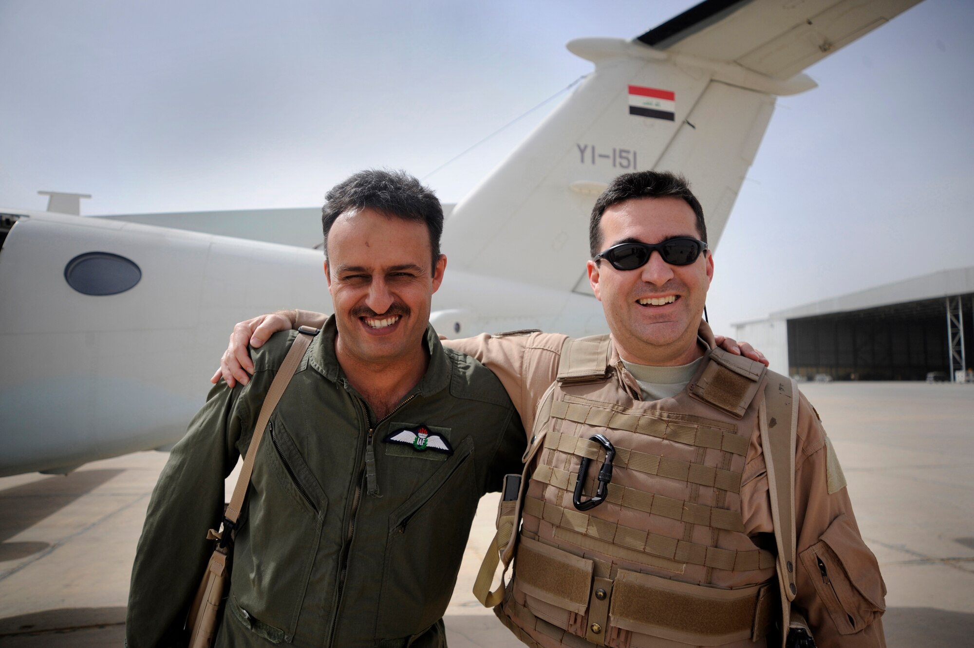 U.S. Air Force pilot, assigned to the Coalition Air Forces Training Team embraces his Iraqi counterpart after a Intelligence, Surveillance and Reconnaissance mission operations, May 8, 2009. (U.S. Air Force Photo by Staff Sgt. Shawn Weismiller)