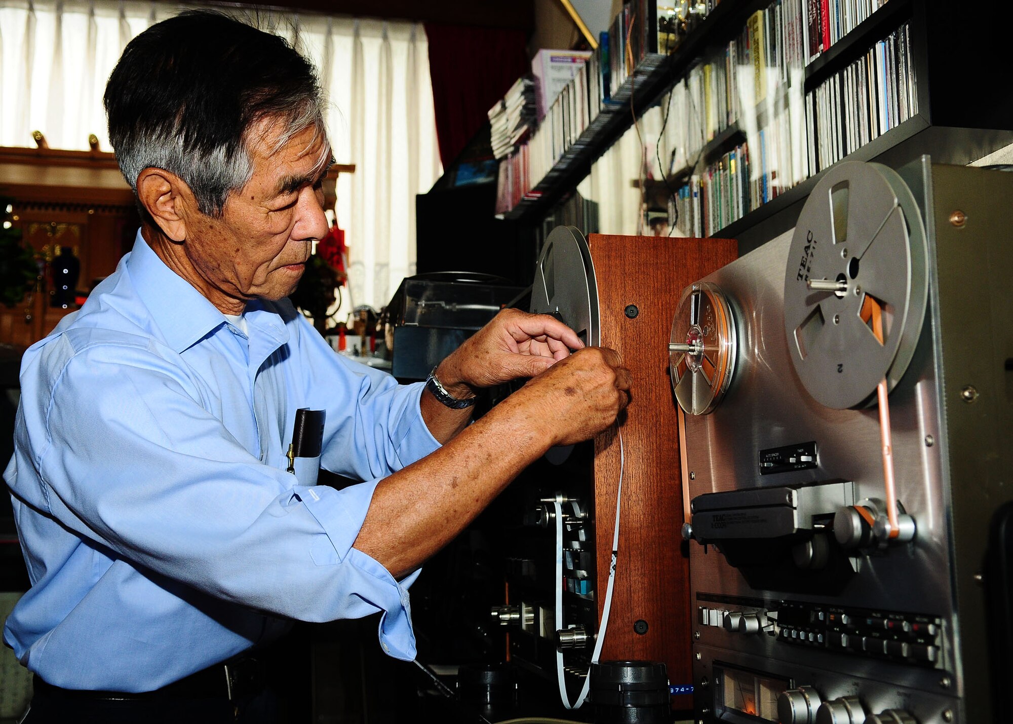 HAMURA, Japan -- Mr. Shoichi Takuchi changes the reel to reel audio recording of the Far East Network in his home in Hamura, Japan June 11. Mr. Takuchi made these recordings when he was a young man to practice his English and to listen to the music. FEN started broadcasting on Sept. 12, 1945 and broadcasted for 52 years until 1997 when the FEN network changed to the American Forces Network we have today.  (U.S. Air Force photo/Airman 1st Class Michael Dillon)