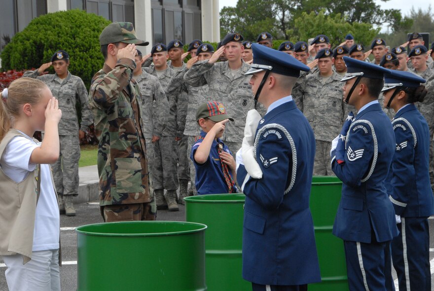 Kadena members along with local Girl and Cub Scouts render salutes to the flags they have retired during the 2009 Air Force Sergeants Associations "Flag Day Ceremony", June 12, Kadena AB, Japan. During this ceremony out of service flags were retired by being burned. (U.S. Air Force photo/Staff Sgt. Christopher Hummel)