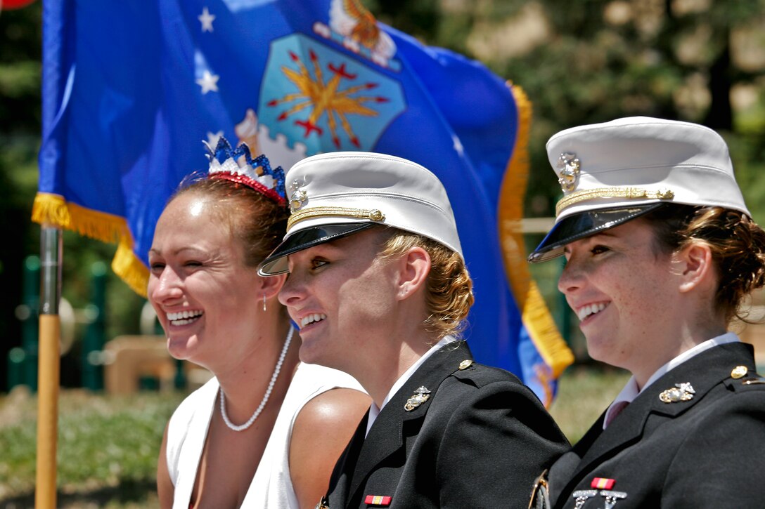 U.S. Marine Corps 1st Class Midshipman Lauren Reisinger, center, Kathryn Reisinger, her sister, left, and master of ceremonies for her personalized commissioning ceremony to second lieutenant, 2nd Lt. Hannah Feuerstein, right, listen during Reisinger’s ceremony which was held in her home town of San Rafael, Calif., June 14, 2009.