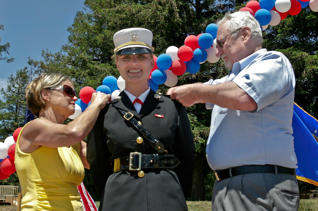 U.S. Marine Corps 2nd Lt. Lauren Reisinger looks into the audience of family and friends as her parents, Victoria and Joseph Reisinger, pin on the bars signifying second lieutenant during Reisinger’s commissioning ceremony in San Rafael, Calif., June 14, 2009.