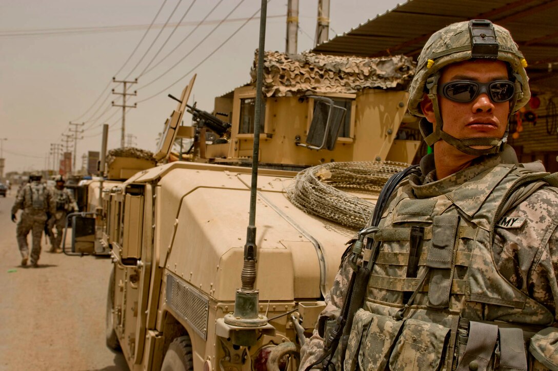 U.S. Army soldiers patrol the streets of Baghad with Iraqi national police, June 6, 2009. The U.S. soldiers are assigned to the 1st Battalion, 82nd Field Artillery.