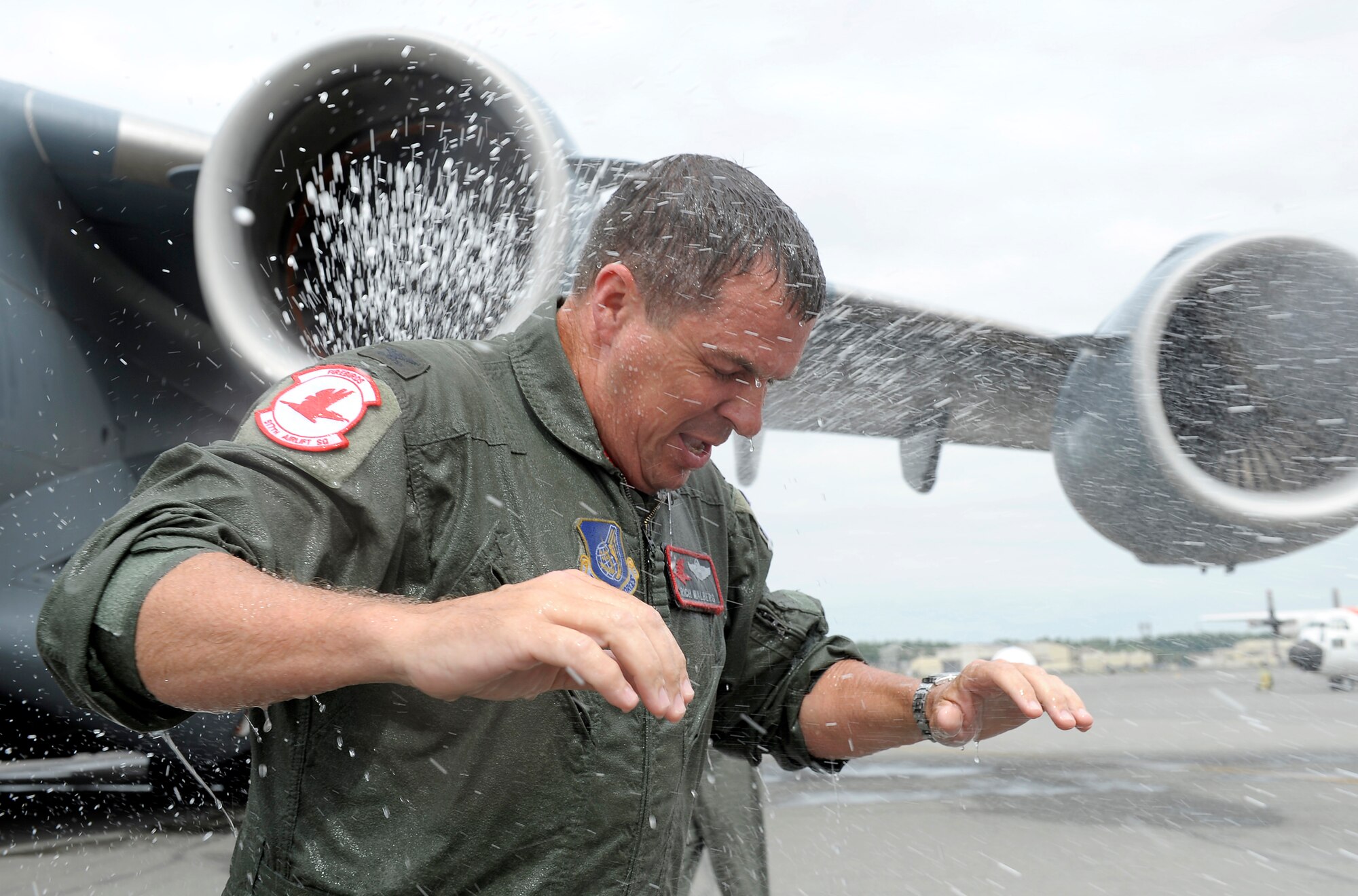 ELMENDORF AIR FORCE BASE, Alaska -- Col. Rich Walberg is doused with water after his last military flight June 16. Colonel Walberg retires from active duty June 19. His final assignment was as the 3rd Wing vice commander. (U.S. Air Force photo/Master Sgt. Keith Brown)
