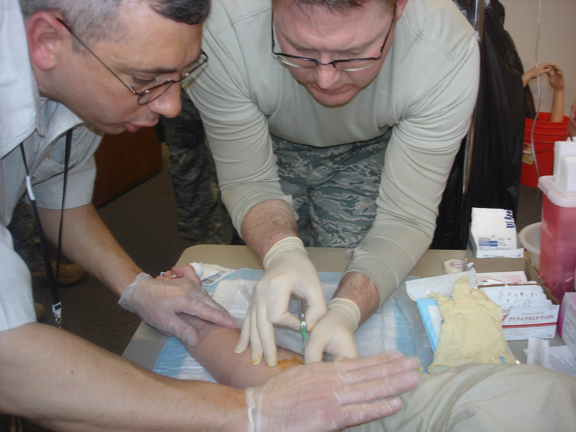 Major Chuck Pratt from the 129th Aircraft Maintenance Squadron administers an I.V. during the Combat Life Saver Course at Fort Dix, NJ, April 1. The course was part of Combat Skills Training for Joint Expeditionary Tasked Airmen. (Photo courtesy of Maj. Charles Pratt)
