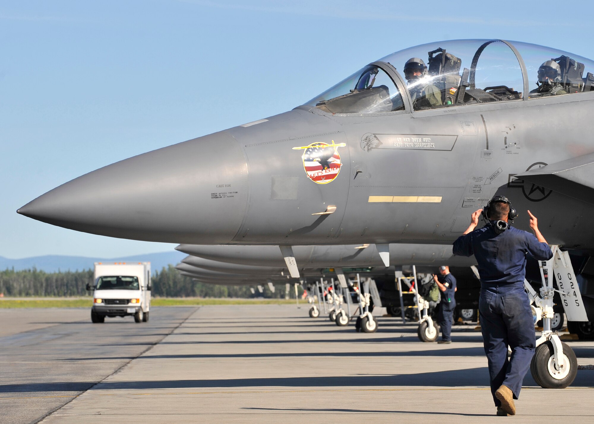 Senior Airman Cesar Zayas marshalls an F-15 Strike Eagle prior to take off during NORTHERN EDGE 2009 at Eielson Air Force Base, June 16. NE09 is an exercise designed to sharpen the U.S. Armed Forces' skills and develop interoperable plans and programs. Airman Zayas is a dedicated crew chief assigned to the 366th Aircraft Maintenance Squadron, Mountain Home AFB, Idaho. (U.S. Air Force photo/Staff Sgt. Christopher Boitz)
