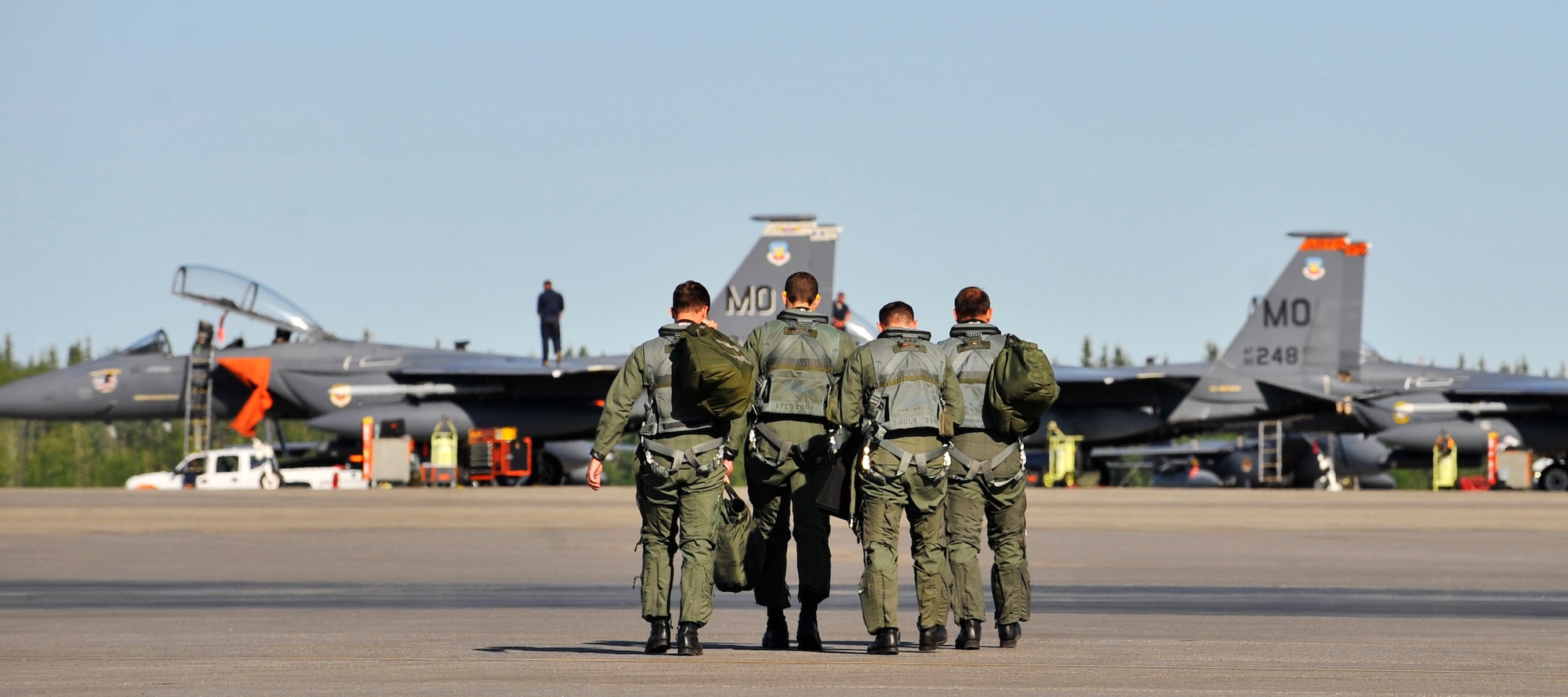 F-15 Strike Eagle aircrew step to their planes during NORTHERN EDGE 2009 at Eielson Air Force Base, June 16. NE09 is a large scale exercise hosted in Alaska to improve command, control and communications between the Armed Services. The aircrew is assigned to the 391st Fighter Squadron, Mountain Home AFB, Idaho. (U.S. Air Force photo/Staff Sgt. Christopher Boitz)