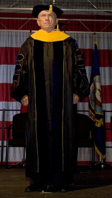 Col.(ret) Frank Borman, Test Pilot School graduation guest speaker, stands before the audience June 13. The graduating class received a masters degree in Flight Test Engineering. In his speech, Colonel Borman addressed Family, Country and Religion, things he said are the reason we fly. (Air Force photo/Mike Yncera) 