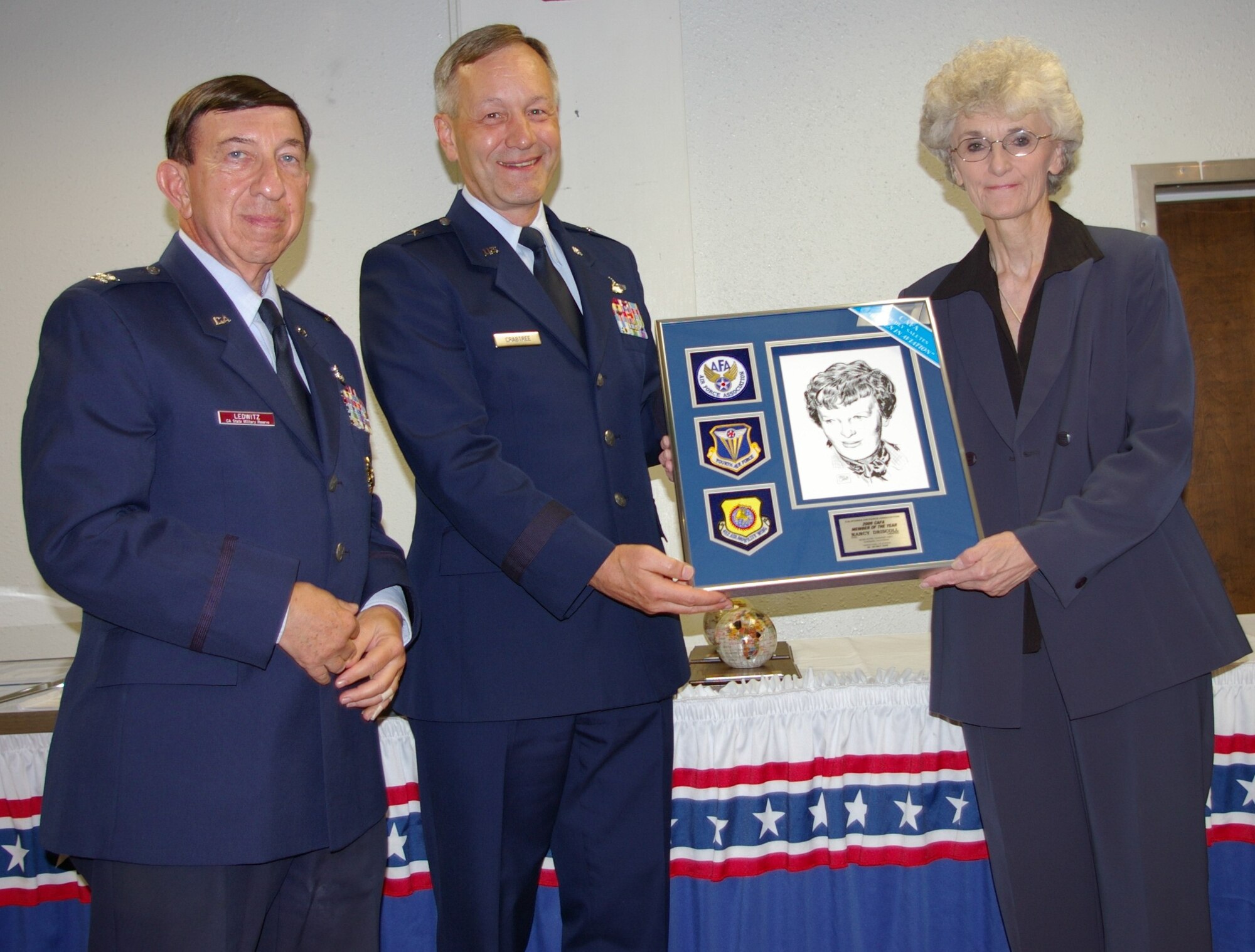 MEMBER OF THE YEAR: Col. Ledwitz and Brig. Gen. Crabtree present Nancy Driscoll with the CAFA Member of the Year award. Driscoll, a retired Air Force Colonel, is the Chief of Bioenvrionmental at March. (U.S. Air Force photo by George Williams)