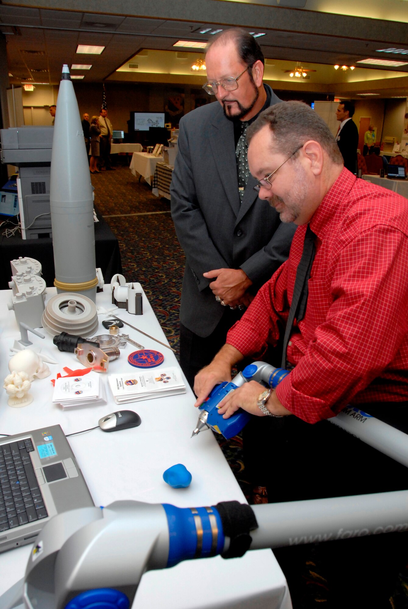 Mr. James Moore and Mr. Carl Cummings from the 982nd Maintenance Squadron demonstrate the capabilities of a training developer on a squeeze ball June 16 at the Sheppard Technology Expo. Companies attended the event from all over the country to showcase their products and learn the needs of Sheppard so as to better develop products that support the training mission. (U.S. Air Force photo/ Mike Litteken)