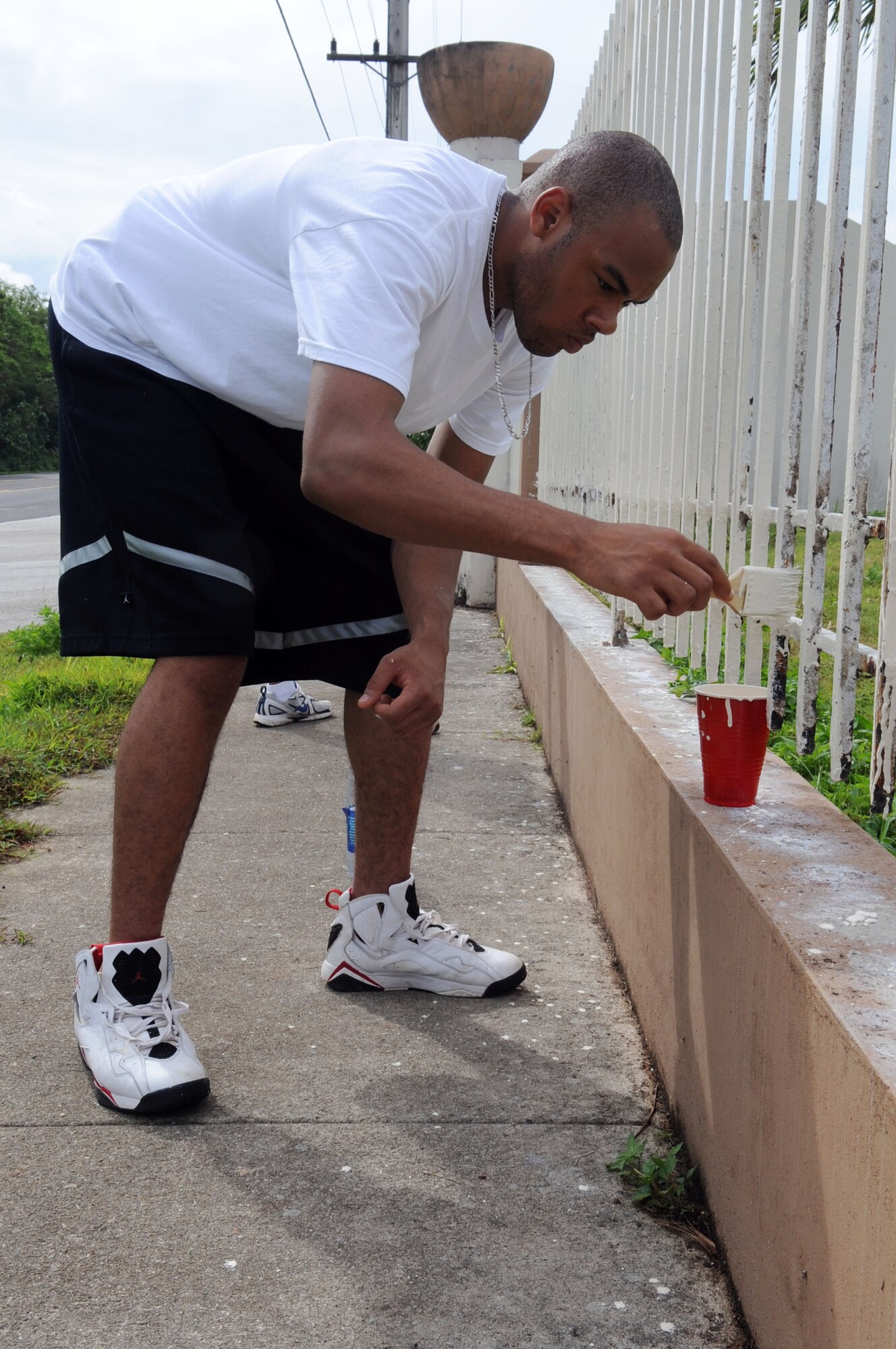 AGANA, Guam – Airman 1st Class Raymond L. Pigg, 525th Expeditionary Aircraft Maintenance Unit weapons load crew member, participates in a community service project at Machananao Elementary School lead by the Guam Girl Scouts Andersen Air Force Base Troop 046 June 6. Airman Pigg, a Dos Palos, Calif., native, is deployed to Guam from Elmendorf AFB, Alaska. (U.S. Air Force photo by Staff Sgt. Jennifer Redente)