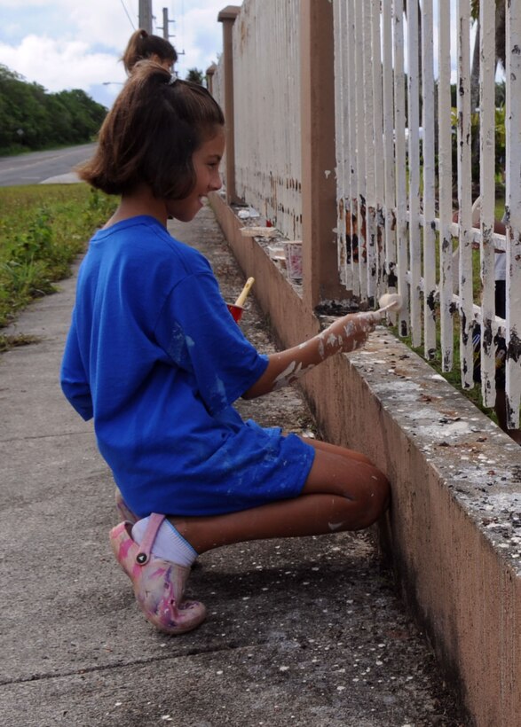 AGANA, Guam – Gretchen P. Richter, 10, paints a fence June 6 at Machananao Elementary School as part of a community service project her Girl Scouts Troop planned. Gretchen is a Junior Girl Scout with the Guam Girl Scouts Andersen Air Force Base Troop 046 and is the daughter of Maj. Clayton Richter, 36th Wing Legal Office deputy staff judge advocate. More than 100 Airmen from Andersen AFB, Guam, assisted the Girl Scouts in scrapping rust off and painting the fence. (U.S. Air Force photo by Staff Sgt. Jennifer Redente)