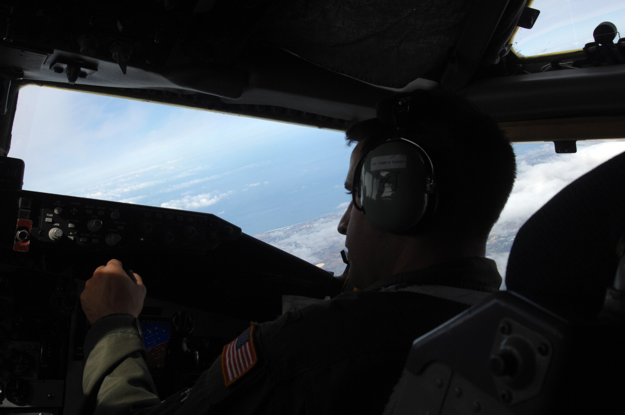 2nd Lt. Charles Roberts of the 336th Air Refueling Squadron, March ARB, mans the throttles and performs the landing checklist in a KC-135R Stratotanker during a training flight approach on San Clemente Island.  (U.S. Air Force photos by Senior Master Sgt. Michael Du)