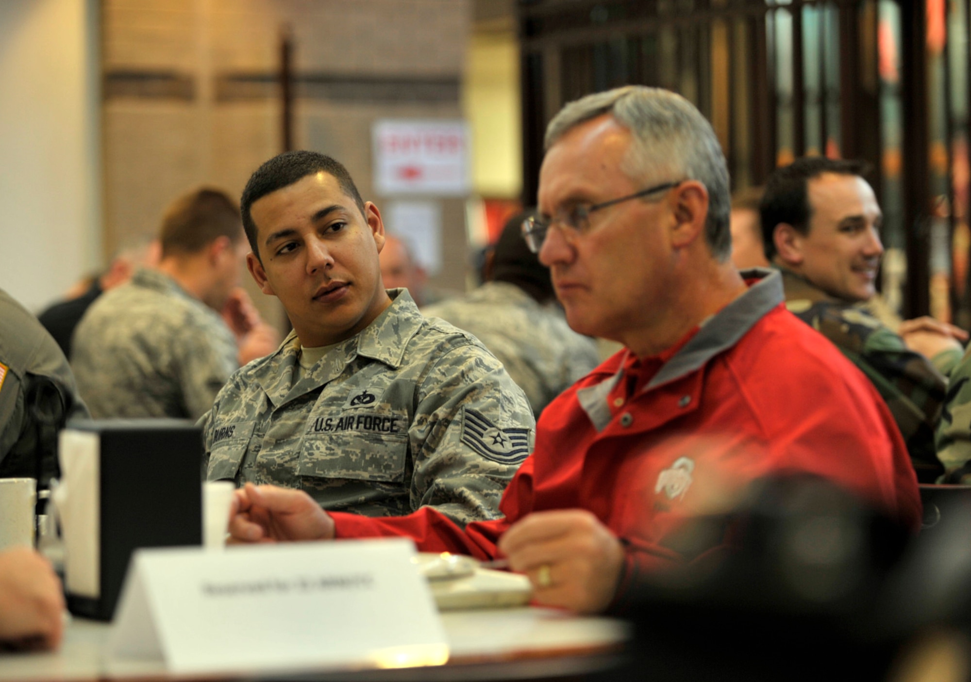 Tech. Sgt. Howard Burns listens to Ohio State football coach Jim Tressel during a breakfast at McConnell Air Force Base, Kan., on May 28. Sergeant Burns, a Reservist assigned to the 931st Civil Engineer Squadron at McConnell, was part of a group of Airmen selected to eat with Tressel, Wake Forest coach Jim Grobe and Air Force coach Troy Calhoun, during the first part of Coaches Tour 2009. (U.S. Air Force photo/Tech. Sgt. Jason Schaap)