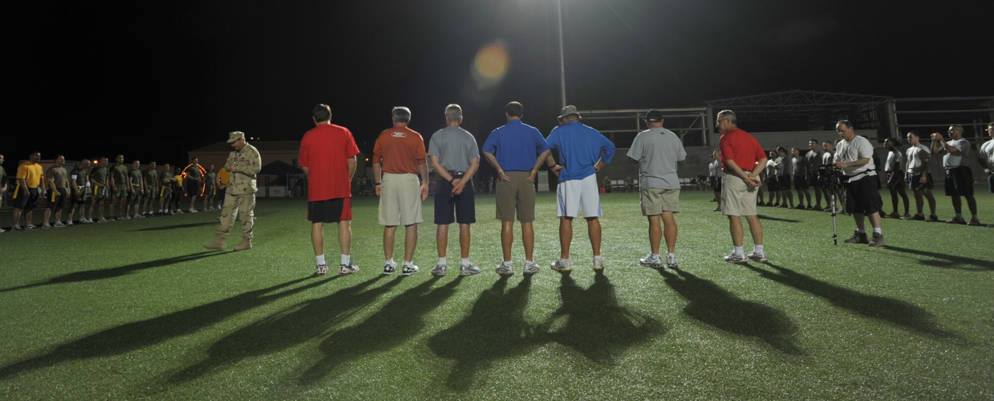 Seven NCAA football coaches--Houston Nutt of Ole Miss, Mack Brown of Texas, Coach Emeritus Tommy Tuberville, Troy Calhoun of Air Force, Rick Neuheisel of UCLA, Jim Grobe of Wake Forest, and Jim Tressel of Ohio State--are introduced before an Air Force/Army versus Marines/Navy flag football game at Camp Lemonier in Djibouti, Africa, on June 2. The coaches visited the camp during Coaches Tour 2009, a morale-boosting mission that also brought them to servicemembers in Europe and Iraq. (U.S. Air Force photo/Tech. Sgt. Jason Schaap) 