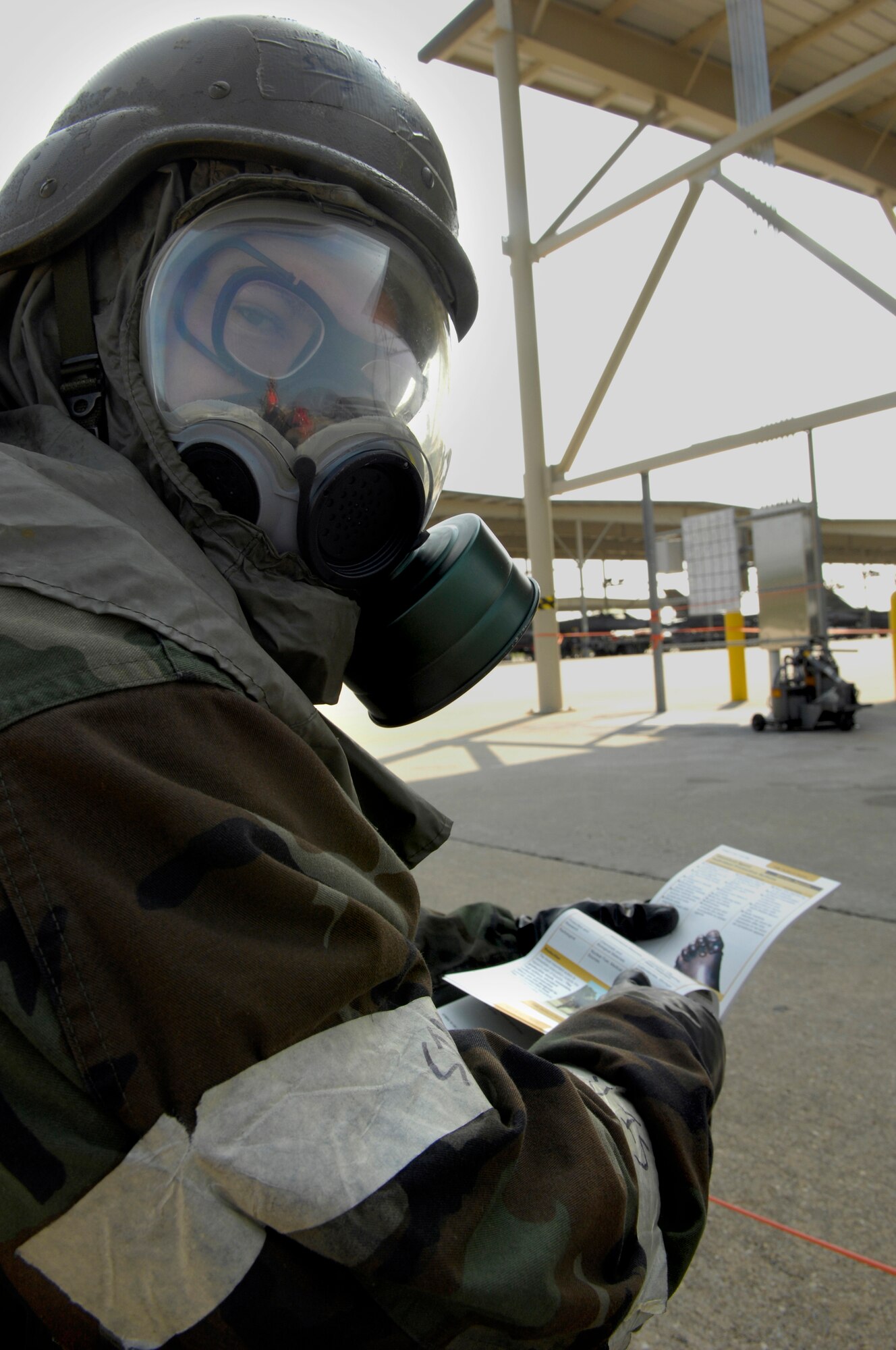 SHAW AIR FORCE BASE, S.C. -- Staff Sgt. Christian Leugers, 20th Aircraft Maintenance Squadron personnel, reviews his Airman's Manual before checking M8 chemical agent detection paper for exposure during Team Shaw's operational readiness inspection, June 16. The ORI will evaluate Shaw's ability to survive and operate in combat conditions. (U.S. Air Force photo/Senior Airman Kathrine McDowell)