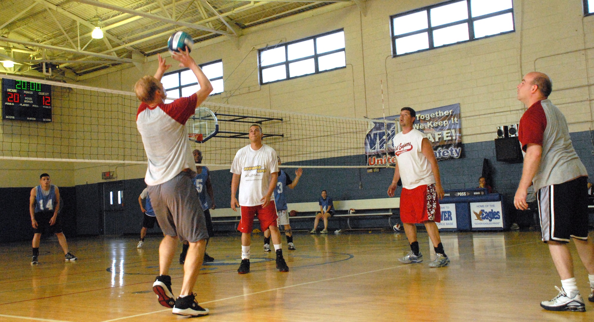 Jeffrey Fowlkes, 436th Civil Engineer Squadron, sets the ball for his team during the volleyball championship game at the Fitness Center June 3. The 436th CES team defeated the 436th Maintenance Squadron out of five games. (Air Force photo/ Airman 1st Class Shen-Chia Chu)
