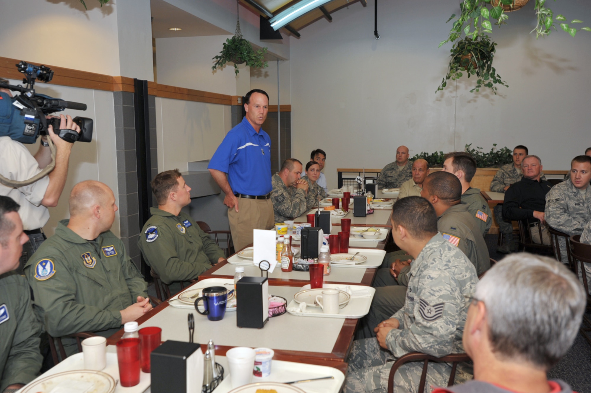 Troy Calhoun, head football coach at the Air Force Academy, talks to Airman during a breakfast at McConnell Air Force Base, Kan., on May 28. Coaches Tour 2009, a morale-boosting mission that brought NCAA football coaches to U.S. servicemembers, started at McConnell before a KC-135 Stratotanker from the base was used to fly the coaches overseas. (U.S. Air Force photo/Tech. Sgt. Jason Schaap)