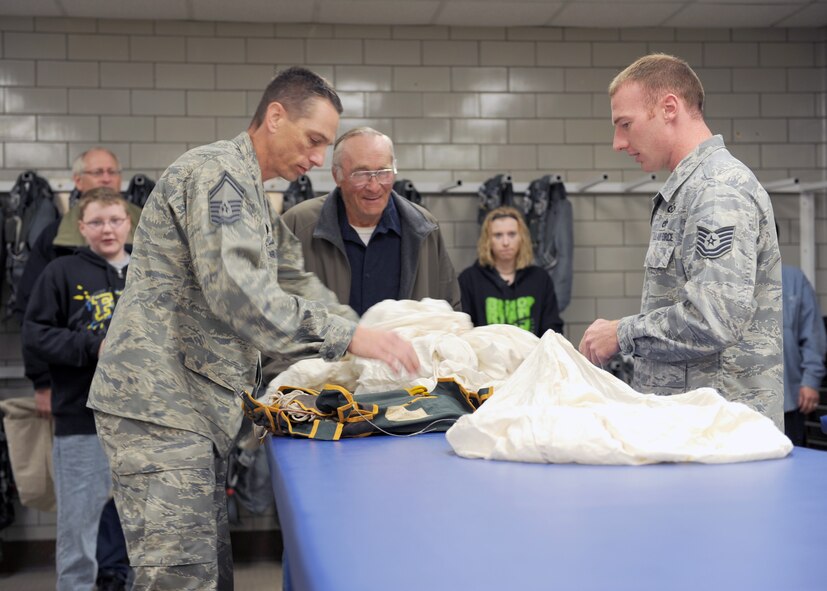 MINOT AIR FORCE BASE, ND -- Senior Master Sgt. Kenneth Boteler, Air Flight Crew Equipment superintendent, and Tech. Sgt. Dennis Lotito, noncommissioned officer in charge, both from the 5th Operational Support Squadron’s Air Flight Crew Equipment office, unpack a Japanese parachute from World War II, here June 11. The parachute is made of heavy silk; the date of manufacture is Nov. 17, 1923. The owner of the parachute, Mr. Harold Uhlich of Garrison, N.D., acquired the piece while serving in a security detail in Sasebo, Japan for the U.S. Marine Corps from 1944 to 1946. (US Air Force photo by Staff Sgt. Keith Ballard)