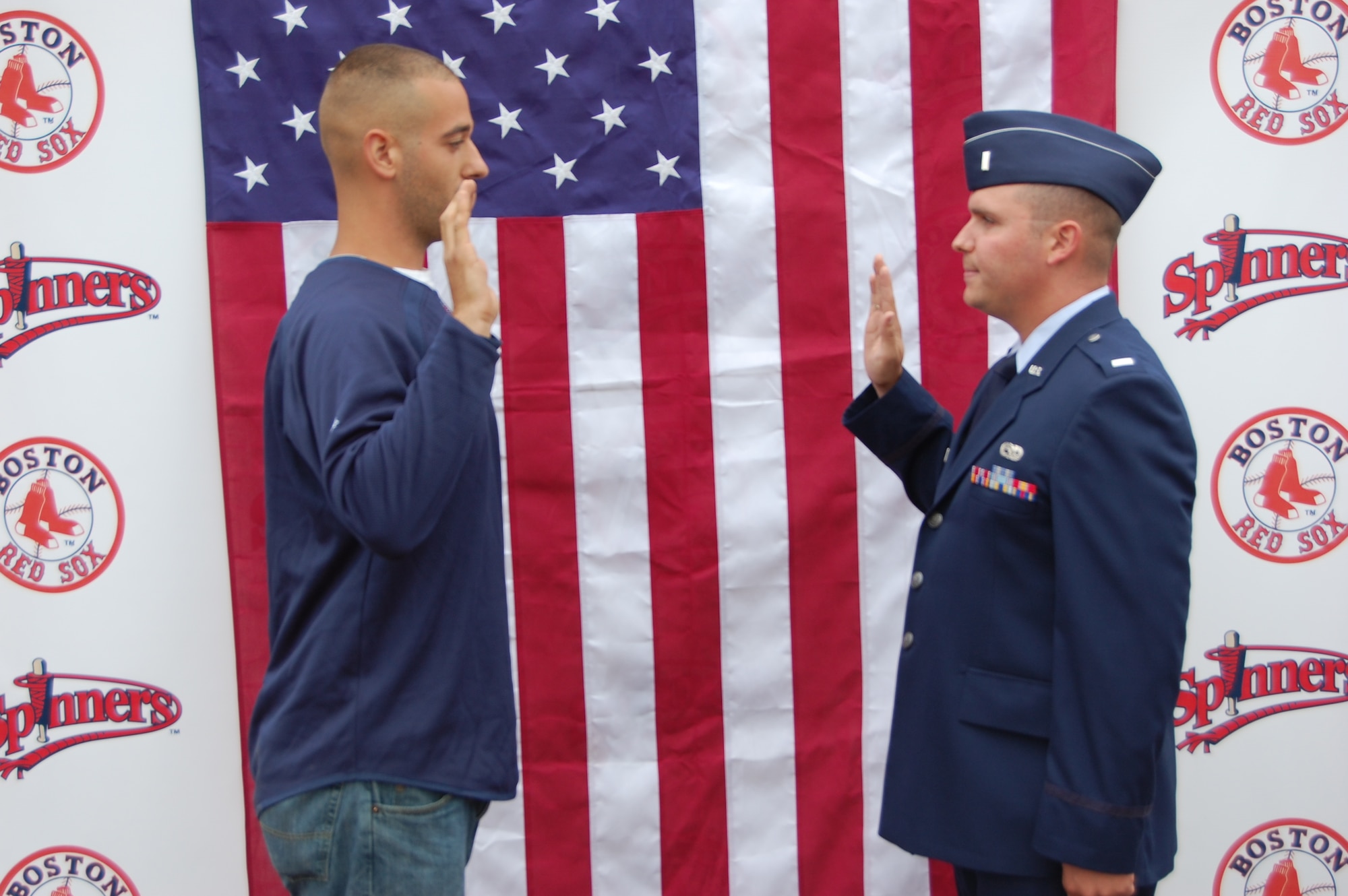 First Lt. Jason Patterson, 853rd Electronic Systems Group executive officer, swears in Jeffrey Paolino during an induction ceremony at Edward A. LeLacheur Park, Home of the Lowell Spinners baseball team, June 11.  Now-Airman Paolino, who serves as grounds manager at the park, will also serve as a Security Forces Airmen in the Air Force Reserve and will be stationed at Westover Air Reserve Base, Mass.  (Courtesy Photo)
