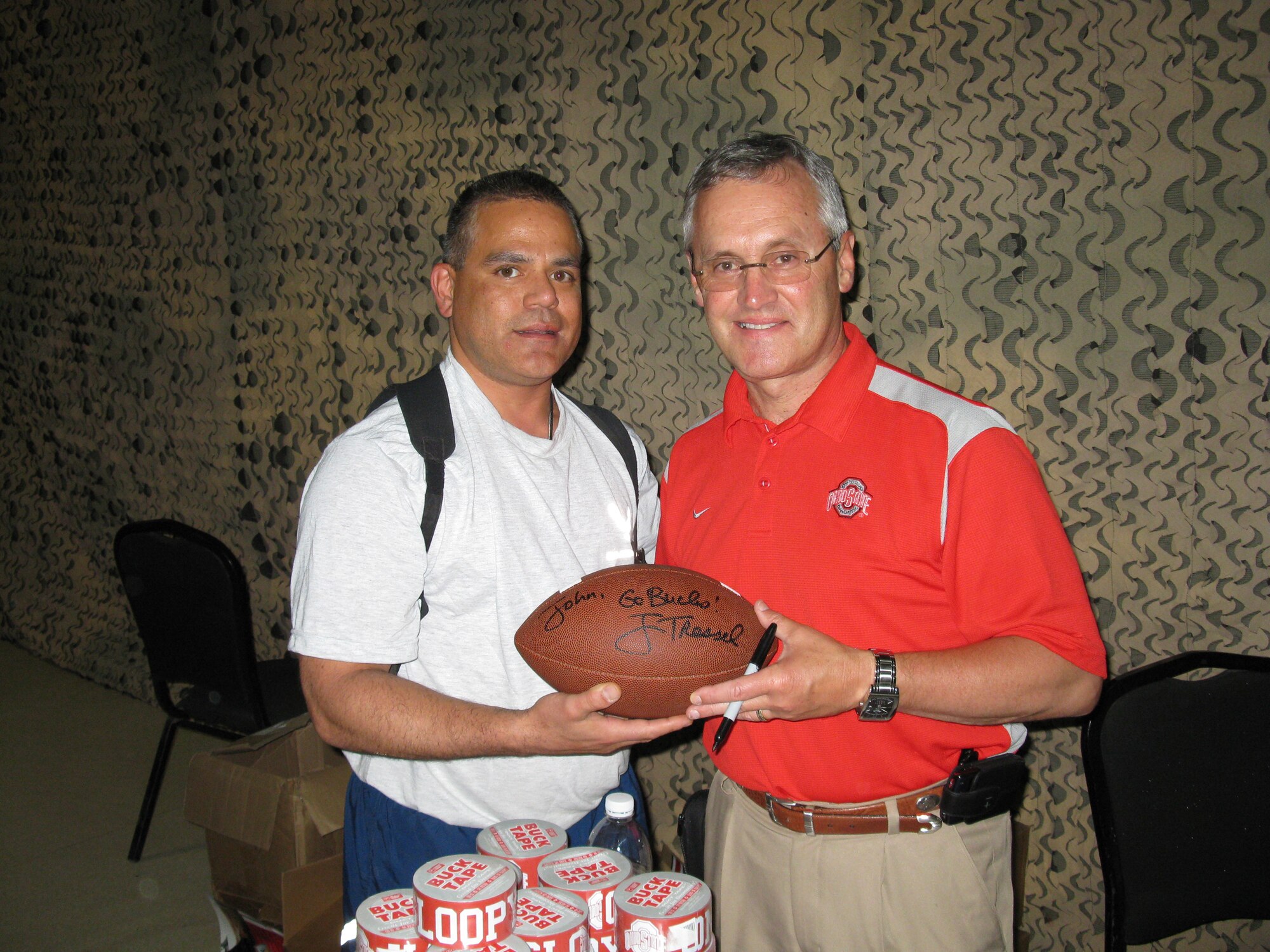 WRIGHT-PATTERSON AIR FORCE BASE, Ohio – Maj. John Marang, 87th Aerial Port Squadron, currently assigned to the 332nd Expeditionary Logistics Readiness Squadron, Joint Base Balad, poses with Ohio State University Coach Jim Tressel.  Coach Tressel was one of seven NCAA football coaches that participated in Coaches Tour 2009, a morale-boosting mission that brings NCAA football coaches to U.S. servicemembers currently deployed. (Courtesy photo)