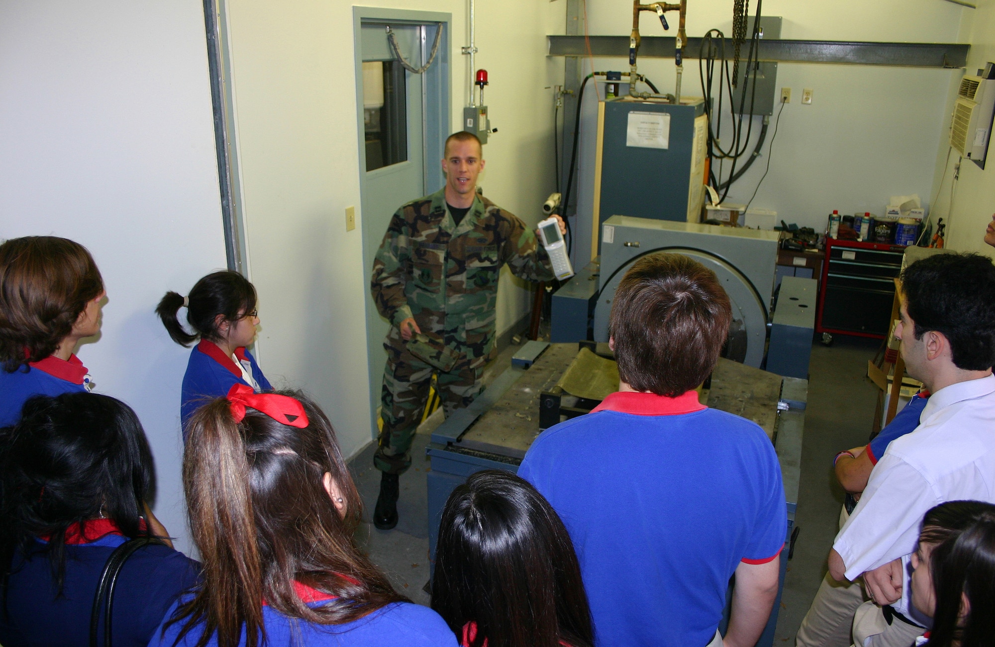 Capt. Gary Beisner, of the Aeromedical Test Branch at Brooks City-Base, Texas, demonstrates a medical test analyzer to students at the Harmony Science Academy May 26.  The science and engineering career field management team at the Air Force Personnel Center, Randolph Air Force Base, Texas,  have partnered with the San Antonio academy to establish mentors and other volunteers at local bases. (U.S. Air Force photo/Richard Salomon)
