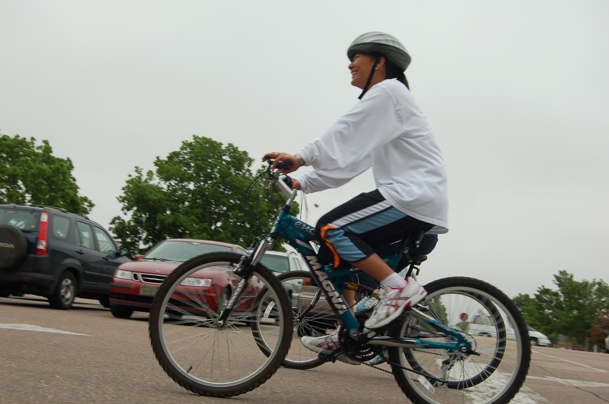 Tech. Sgt. Catherine Gsell, 21st Dental Squadron noncommissioned officer in charge of training at the Area Dental Lab, rides into the sports and fitness center parking lot during the Bike to Work scavenger hunt June 10. Two 21st DS bicyclists borrowed community bikes from the Health and Wellness Center’s Bike Borrow program that kicked-off the same day. Eight bikes are available through the Bike Borrow program at the HAWC for one day use. (U.S. Air Force photo by Thea Skinner)