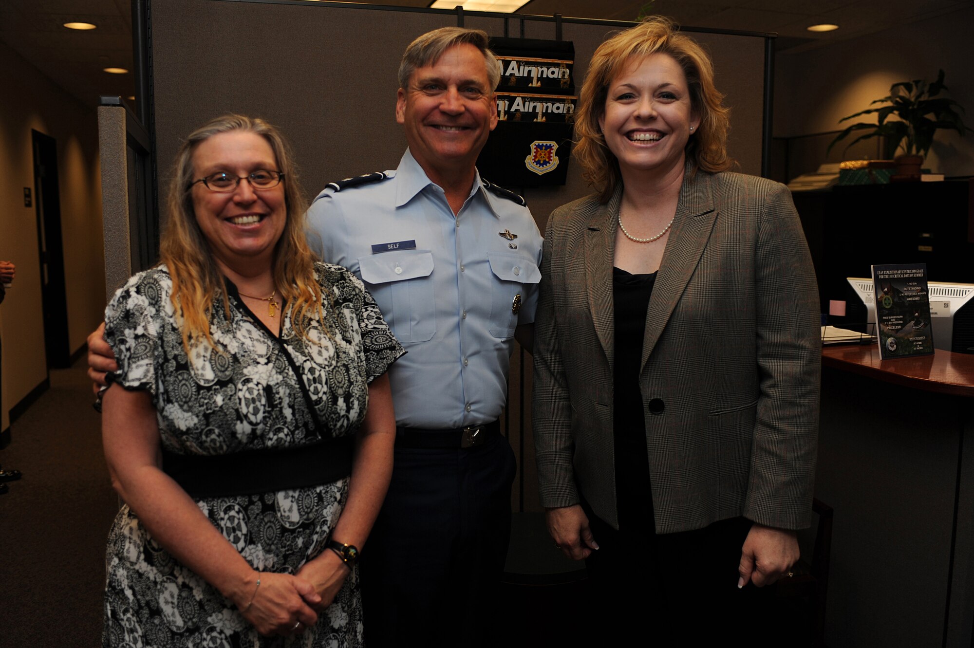 Maj. Gen. Kip Self, U.S. Air Force Expeditionary Center commander, stops for a photo with Mrs. Christy Dickinson, financial manager, and Ms. Sandra Lewis, resource advisor, both with the Expeditionary Center, June 15 on Joint Base McGuire-Dix-Lakehurst, N.J.  Mrs. Dickinson and Ms. Lewis saved the life of Master Sgt. Dianna Ackerman after an allergic reaction. They are credited with an immediate response in getting Sergeant Ackerman to a medical facility while on temporary duty in San Antonio, Texas. Sergeant Ackerman is now back home and doing well.  (U.S. Air Force Photo/Staff Sgt. Nathan G. Bevier) 