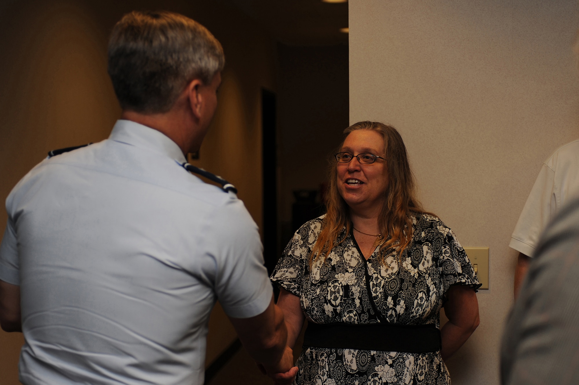 Maj. Gen. Kip Self, U.S. Air Force Expeditionary Center commander, thanks Ms. Sandra Lewis, resource advisor with the Expeditionary Center, by presenting her with a coin June 15 on Joint Base McGuire-Dix-Lakehurst, N.J.  Ms. Lewis and Mrs. Christy Dickinson, financial manager with the Expeditionary Center, saved the life of Master Sgt. Dianna Ackerman after an allergic reaction. They are credited with an immediate response in getting Sergeant Ackerman to a medical facility while on temporary duty in Texas. Sergeant Ackerman is now back home and doing well.  (U.S. Air Force Photo/Staff Sgt. Nathan G. Bevier) 