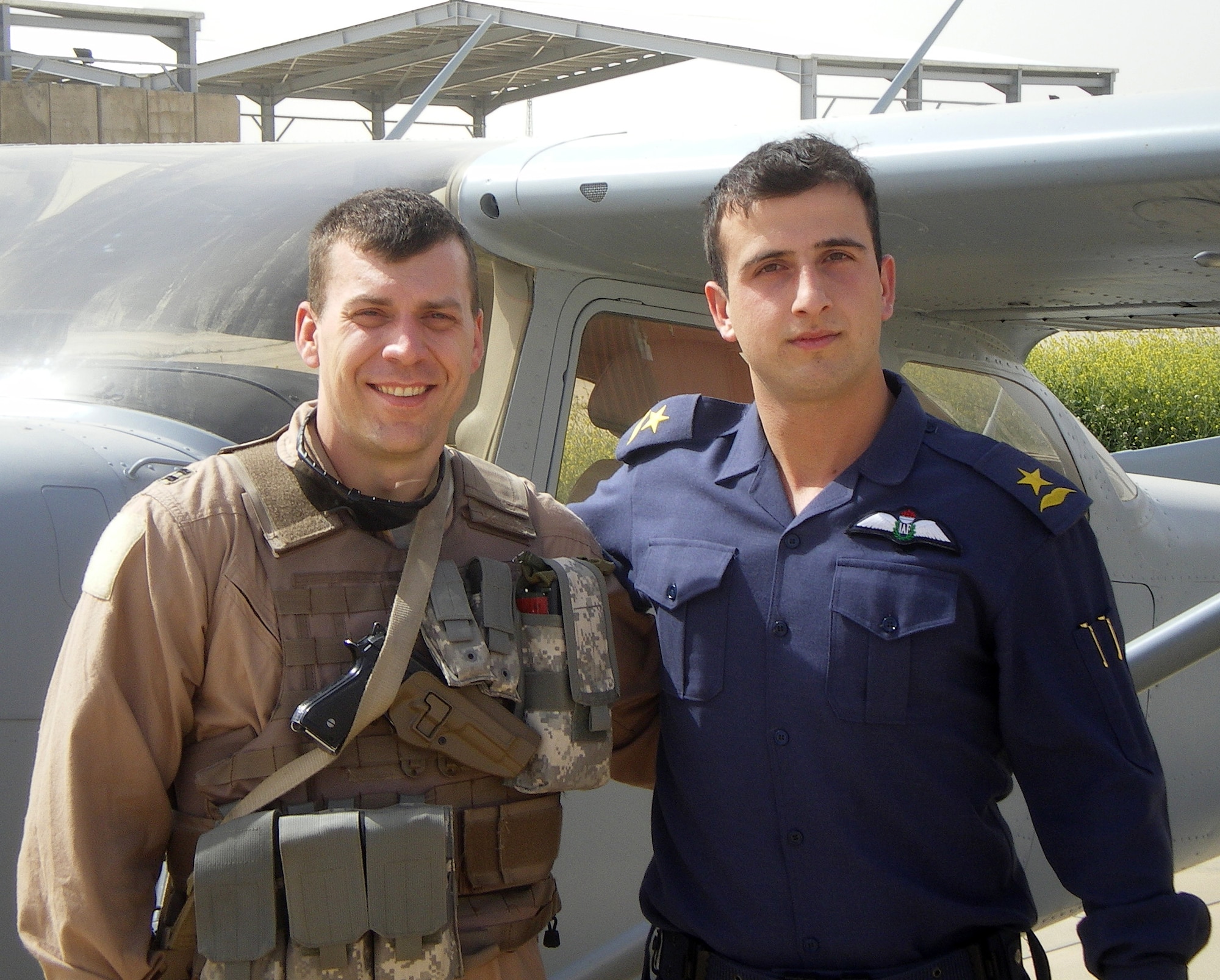 Capt. Craig Morash, left, and one of his newly graduated student pilots, Iraqi air force Lt. Ali Sabah, pose together at Kirkuk Air Base, Iraq. Lieutenant Sabah will be a first assignment instructor pilot with the Iraqi air force. Captain Morash, a T-38 instructor pilot with the 25th Flying Training Squadron at Vance, was awarded eight medals for his achievements during a six-month deployment with the Coalition Air Forces Training Team at Kirkuk AB. (Contributed photo)