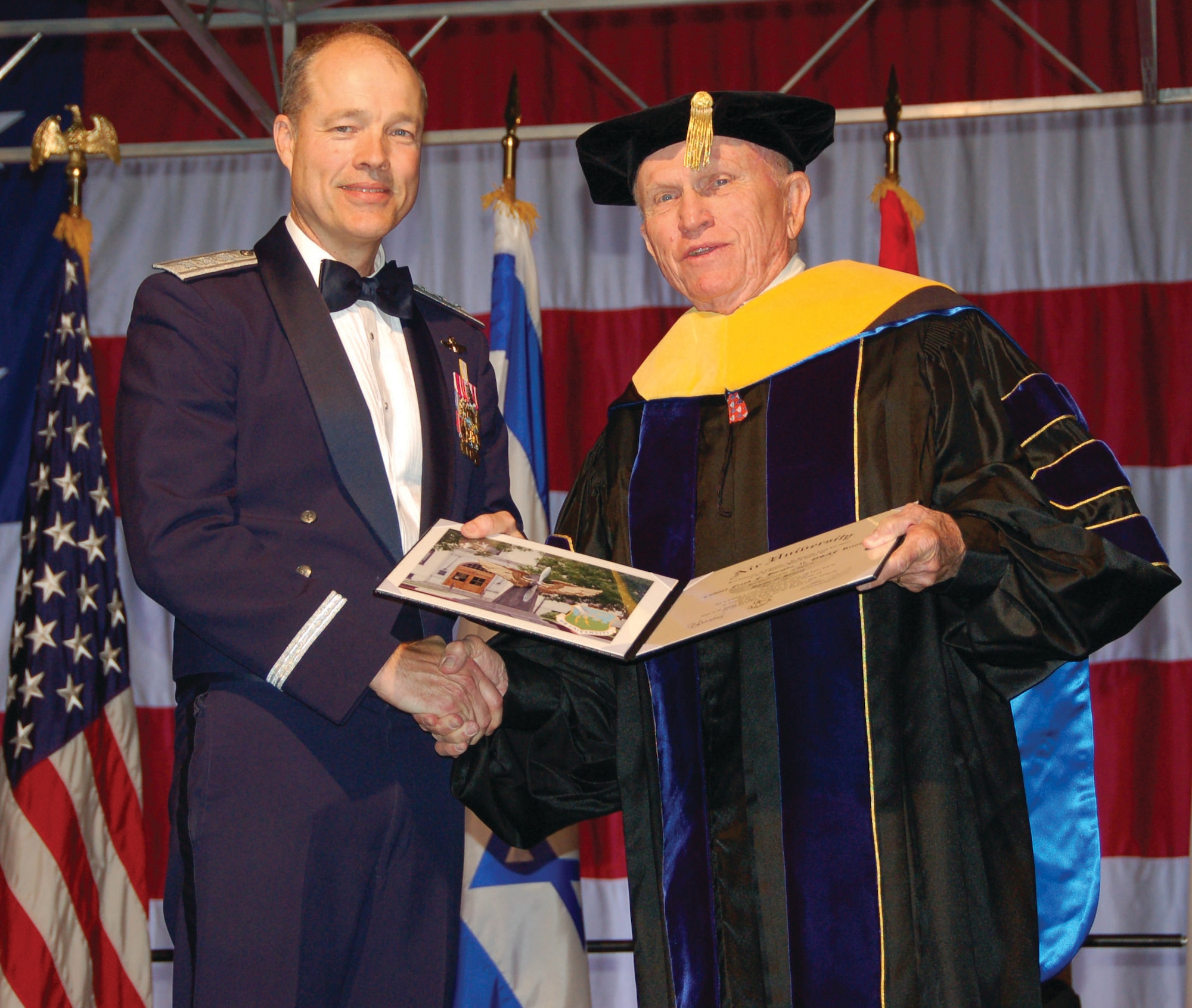 Lt. Gen. Allen G. Peck, the Air University commander honored retired Col. Frank Borman, former astronaut and Air Force officer with an Air University honorary doctor of science degree at the USAF Test Pilot School graduation Saturday. Colonel Borman led the Apollo 8 to be recognized as the first spacecraft to orbit the earth. (U.S. Air Force photo/Senior Airman Melissa Copeland) 